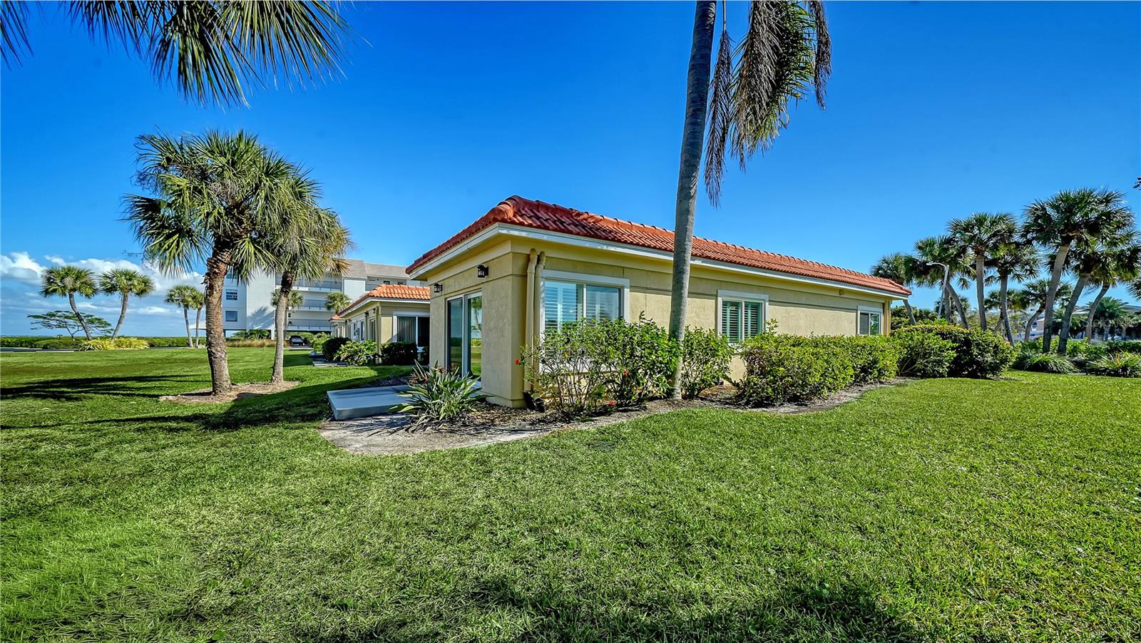 AMAZING $51,000 PRICE IMPROVEMENT! YOUR SUNRISE SANCTUARY! YOUR SUNSET ESCAPE! An End Unit Villa—Steps From Both Shores! There’s a moment just before sunrise—when soft light touches the bay and the world feels brand new. From this beautifully updated 1504 sq foot, 3-bedroom, 2-bath end-unit villa, you wake to that glow each morning. And while the bay lies just a short stroll from your door—where dolphins and manatees grace the shoreline—the sense of tranquility begins the moment you step inside your villa. Welcome to your story at Windward Bay, Loved for 33 Years, Transformed for the Next Chapter! Brand-new luxury vinyl plank flooring stretches throughout the living spaces. Custom White wooden plantation shutters open like pages of a book, revealing light-filled rooms, a bright inviting great room and a refreshed kitchen where new soft-closing cabinetry meets the timeless richness of granite countertops. Being a corner end unit means privacy, extra windows, and the kind of natural light you feel more than you see. The great room spills out to your private outdoor patio—perfect for morning coffee, late lunches, or evening breezes. And as evening arrives, simply walk across the street. The Gulf paints the sky in gold and coral, offering unforgettable sunsets that become a treasured part of your daily rhythm. This home offers peace of mind along with beauty. It’s a place where you can truly exhale. This is effortless, maintenance-free living, where parking sits mere steps from your door and bringing in groceries is a breeze. No elevators. No stairs. No inconvenience. Just the freedom of ground-level coastal life. Here, maintenance-free living means all the big things are already done: the entire exterior was upgraded in 2020 with hurricane-impact windows, hurricane-impact sliding doors, and a new roof. "Pet Friendly" Windward Bay is one of Longboat Key's most beloved waterfront communities—known for its mature landscaping, resort-style amenities, and genuine sense of warmth. People don't just move here; they stay here. In fact, the current owner of this villa has lived here for 33 years, a testament to the comfort, community, and connection the neighborhood provides. Windward Bay isn't just a place to live. It's a place to belong. Spanning 26 lush acres, the community offers three beach access points, a 1/2-mile nature trail, two heated pools, fitness center, sauna, clubhouse, tennis and pickleball courts, kayak launches, boat docks (waitlist), covered parking, and storage. Wildlife is abundant throughout the property, adding magic to everyday life. Financially strong, Windward Bay has completed its Milestone Inspection and Capital Reserve Study. Monthly fees were reduced in 2025 and increased only $13 for 2026. With Downtown Sarasota, St. Armands Circle, Bridge Street, renowned restaurants, championship golf, boutique shopping, and cultural attractions just minutes away, you're perfectly positioned between quiet island tranquility and vibrant coastal life. A Home That Feels Like a Vacation—Every Single Day! A place ready for its next chapter—your chapter. Your Windward Bay story starts here—reserve your private viewing today.