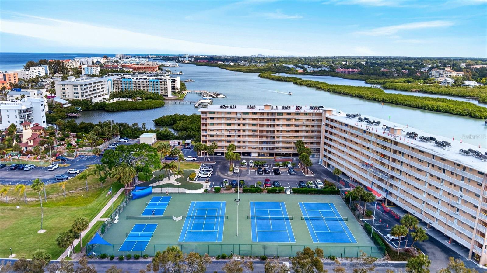 Experience coastal living at its finest in this beautifully appointed, fully furnished, elevated 2nd floor condominium in Indian Shores—just steps from the pristine Gulf beaches. This turnkey 1-bedroom, 1-bath residence offers an exceptional opportunity as both a personal retreat and a high-performing investment property. Currently operating as a successful weekly rental, the unit boasts a strong rental history along with future bookings already in place, providing immediate income potential for the next owner. Thoughtfully designed with an open-concept layout, the interior features stylish coastal décor, a bright and inviting living space, and a private balcony overlooking lush tropical surroundings—perfect for relaxing after a day by the water.  
The spacious bedroom serves as a comfortable retreat, while the well-equipped living area is ideal for entertaining or unwinding. Positioned in a sought-after, short-term rental-friendly community, this property seamlessly blends lifestyle and investment appeal.
Residents and guests enjoy a host of amenities, including boat slips for overnight mooring (first come, first served), a fishing pier, tennis and pickleball courts, as well as a hospitality room and rooftop sun deck offering sweeping water views.
Ideally located near local dining, shopping, and entertainment, this property delivers the quintessential Florida coastal experience. Whether you’re seeking a reliable income-producing asset, a vacation getaway, or both, this exceptional condo is not to be missed.
Schedule your private showing today.
