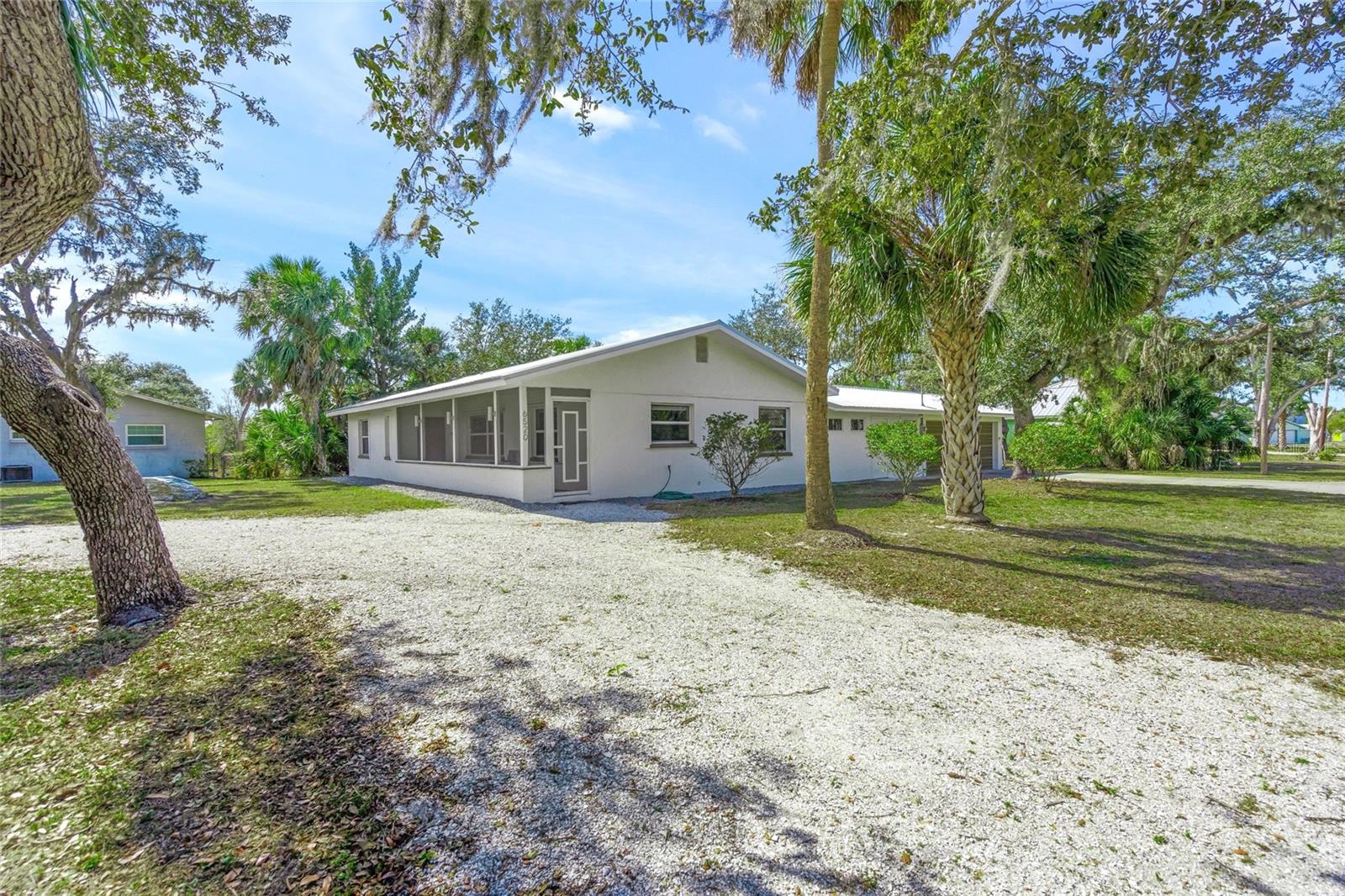 Canal Front home with river access to both Linger Lodge and Jiggs Landing ~ excellent boating & fishing!!  This solidly built 2BR/2BA concrete block home is situated on a rare .39-acre canal front lot—the highest elevation in Marineland—offering peace of mind with no flood insurance required and no history of water issues. Major upgrades include a brand-new Galvalume metal roof (2025), new A/C system (2025), and Acrylic Hurricane Panels for all openings (2020). The home features all new electrical (2012) and updated overhead CPVC plumbing (2012), insulated double-pane windows, extra attic insulation, and a tankless water heater for efficiency and comfort.
Interior highlights include 5¼" baseboards throughout, no popcorn ceilings, durable wood-look tile flooring, and a large, open kitchen with light wood cabinetry and granite countertops, plus an eat-in kitchen area. The floor plan offers both a living room and separate family room for flexible entertaining or everyday living, along with a 5’ x 7’ bonus room ideal for a small home office or fantastic pantry.
A spacious 551 sq. ft. garage with dedicated workspace area provides excellent storage and flexibility. Overlooking the Braden River Canal, this residence enjoys the shading of mature Live Oak trees. With no deed restrictions, bring all the toys! Located less than ½ mile to Jiggs Landing, offering convenient access to the county boat ramp—perfect for boating and outdoor enthusiasts. This location also offers the convenience of shopping and restaurants within minutes, area beaches approximately 12 miles away, but daily fishing or kayaking are just a walk into your own backyard.