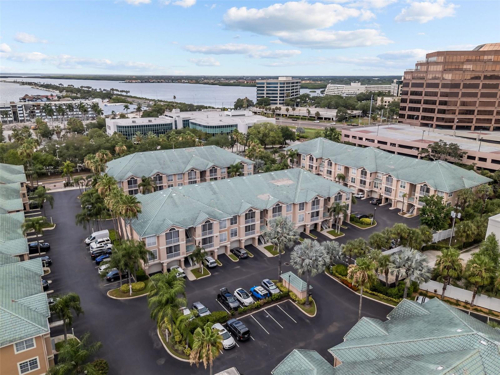Tucked along the shores of Tampa Bay in the gated Island Club at Rocky Point community, this third-floor end-unit condo offers 964 square feet of thoughtfully designed living space plus a deeded one-car garage, in one of the area's most sought-after waterfront enclaves.
Inside, an open floor plan combines the living and dining areas beneath a tray ceiling, with crown molding and built-in features for a polished, upscale feel. The kitchen comes complete with a full appliance suite, refrigerator, range, microwave, dishwasher, washer, and dryer, all included. The primary bedroom offers a peaceful retreat with a spacious walk-in closet, and the adjoining bath rounds out the suite. Step outside to your own private balcony, a quiet spot to enjoy partial bay views with your morning coffee.
As an end unit, this home benefits from extra natural light and added privacy, a quiet perk you'll notice the moment you walk in. And the community itself is reason enough to call this home: residents enjoy a heated saltwater pool, a separate in-ground spa, a fully equipped fitness center, a sauna, and outdoor grilling and shower stations, all just steps from the water. A private community fishing pier stretches out over Tampa Bay, offering front-row views of passing wildlife and the downtown Tampa skyline in the distance.
Set just off Rocky Point, this gated community is minutes from Tampa International Airport, Westshore, and downtown Tampa, with easy access to some of the city's best waterfront dining. Two pets up to 35 lbs are welcome here too, making this a wonderful fit for buyers and their four-legged companions alike.