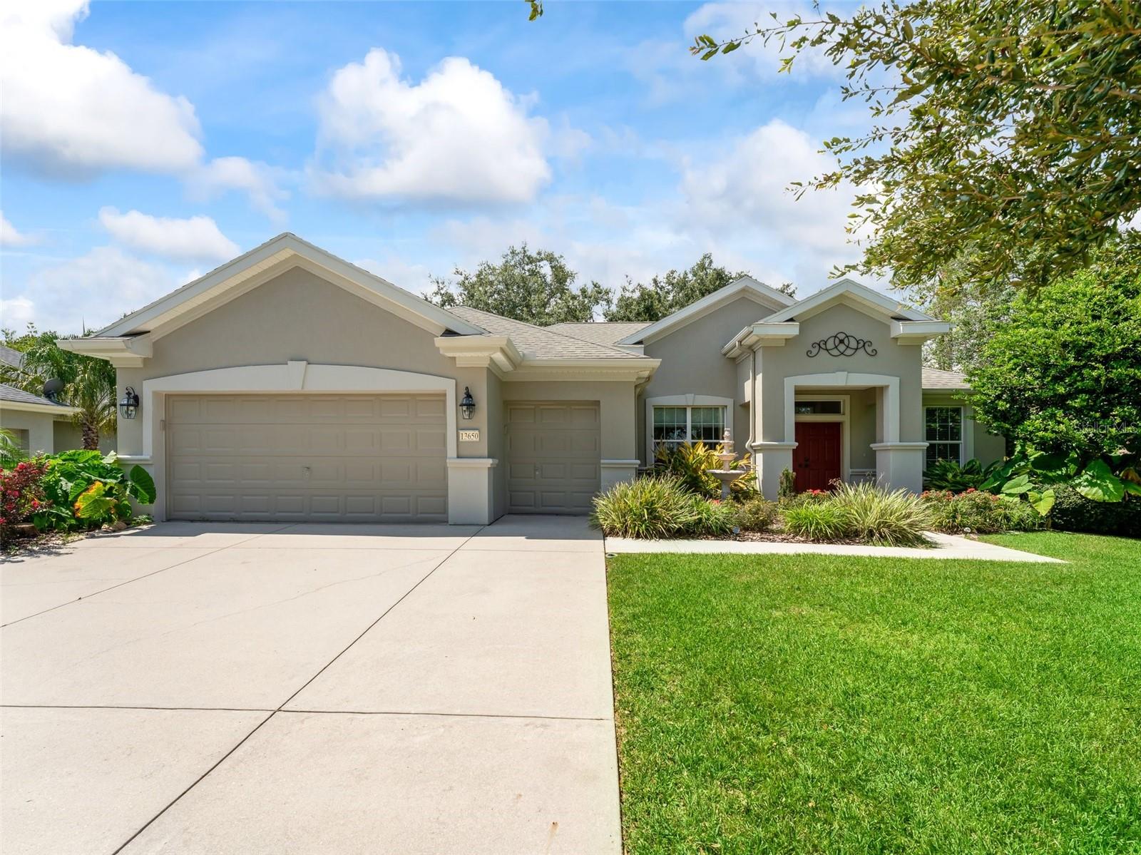 FULLY REPAINTED, INTERIOR AND EXTERIOR IN AUGUST 2022. New Roof Will Be Installed Before Closing. Fantastic home located in Del Webb Spruce Creek Golf and Country Club. DEL WEBB Communities are America's Premier "Active Adult Communities" and World Renown. Stunning ONE OF A KIND, 3/2 split plan ( 3rd bedroom has no closet ). This home has a great location. It is located in the Windward Hills part of Del Webb Spruce Creek Golf and Country Club; on a very private Cul De Sac, just a Short 100 Yard Walk to the Country Club and Restaurant, Main Clubhouse/Community Center and pool. You also can enjoy an unobstructed view of the golf course from the front of the home as there are no homes across the street in the cul-de-sac. Not only are you located close to all of the amenities; you are very close to the main secured gated entrance on 441/27 for Del Webb Spruce Creek Golf and Country Club that makes for easy, quick in out of the community to go shopping or to The Villages, manned 24 hours. Home has a breakfast bar, Island and eat in the kitchen that looks out to your own private landscape oasis. Kitchen with ceramic tile, granite counters and updated appliances. This home has it ALL, hardwood flooring in the living and dining open areas, carpet in bedrooms, master bathroom has double sinks, large walk-in closet, private water closet, walk in shower with garden tub. LARGE interior laundry room, HUGE enclosed lanai with dry bar, storage and remote controlled lighting looking out onto the large private back patio area surrounded by lush landscaping. LARGE extended two car garage plus golf cart garage with lots of built-ins and pulldown storage. There are amenities and organized activities galore as well as planned getaways and trips. You will love living in this manageable golf cart community.