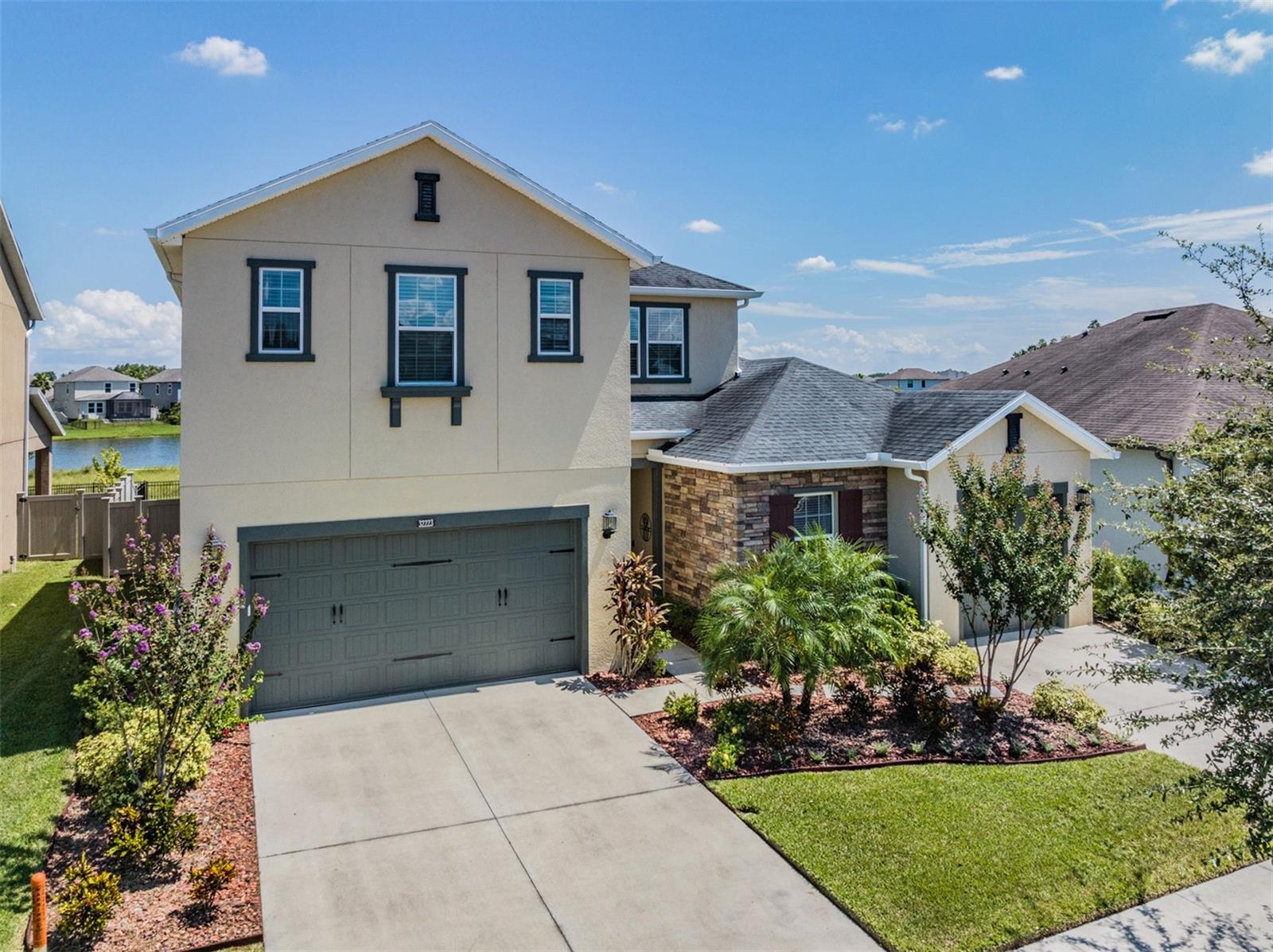 Welcome to this stunning home located in the desirable Meridian at Meadow Point community in Wesley Chapel, Florida. This spacious and beautifully maintained residence offers a perfect blend of comfort and style, with an array of features that will surely impress any discerning buyer. Step inside and be greeted by the open and inviting floor plan with 3,339 sf, boasting 4 bedrooms and 3 baths, providing ample space for a growing family or visiting guests. The bonus room adds versatility, allowing for a home office, media room, or playroom. The large great room is the heart of the home, offering a seamless flow into the kitchen and providing a picturesque view of the lanai. The interior of this home has been tastefully updated, with stunning remodeled bathrooms and a modern kitchen that will delight any chef. Imagine preparing meals in the sleek and stylish space, complete with stainless steel appliances, granite countertops, and an abundance of storage. The kitchen offers upgraded Rejuvination Hardware lighting, Koehler faucet, GE Cafe appliances, custum backsplash with USB/C plugs on outlets. Laundry will be more of a pleasure in this custom laundry room!  An upstairs bedroom is being used as an exercise room with interlocking gym floor which can easily be taken up. Custom crown curtain boxes, crown molding, custom wood ceiling in Dining Room, barn door on hallway, luxury vinyl plank, custom closets in primary, water softener, attic fan, solar (buyer to assume solar loan upon closing, owner's monthly installments for solar have been less than their previous monthly electric bills), and so much more...too many upgrades to mention! Please ask for the list of Upgrades. The exterior features of this home are truly exceptional, starting with the 3 car garage that provides ample space for vehicles and storage with a seperate 2 car and 1 car garage. As you venture outside, you'll discover the true oasis that awaits. The inviting heated and salt water pool with pebble tec finish beckons you to take a refreshing dip, while the fenced yard offers privacy and a safe haven for family or pets to play. Located in the coveted Meridian at Meadow Point community, residents have exclusive access to the amenity center, which includes a fitness center, sparkling pool, tennis/pickle ball courts, basketball courts, park, and playground. Whether you enjoy a leisurely swim or a competitive game, this community has everything you need to lead an active and fulfilling lifestyle. In addition to the amazing amenities, this home is also conveniently located near top-rated schools, shopping centers, local and franchise dining options, and major highways, providing easy access to all that Wesley Chapel and the greater Tampa Bay area have to offer. Don't miss the opportunity to make this exceptional property your own. Schedule your showing today and experience the epitome of Florida living in this highly sought-after community. Ths home is ready for you to just move in and enjoy!