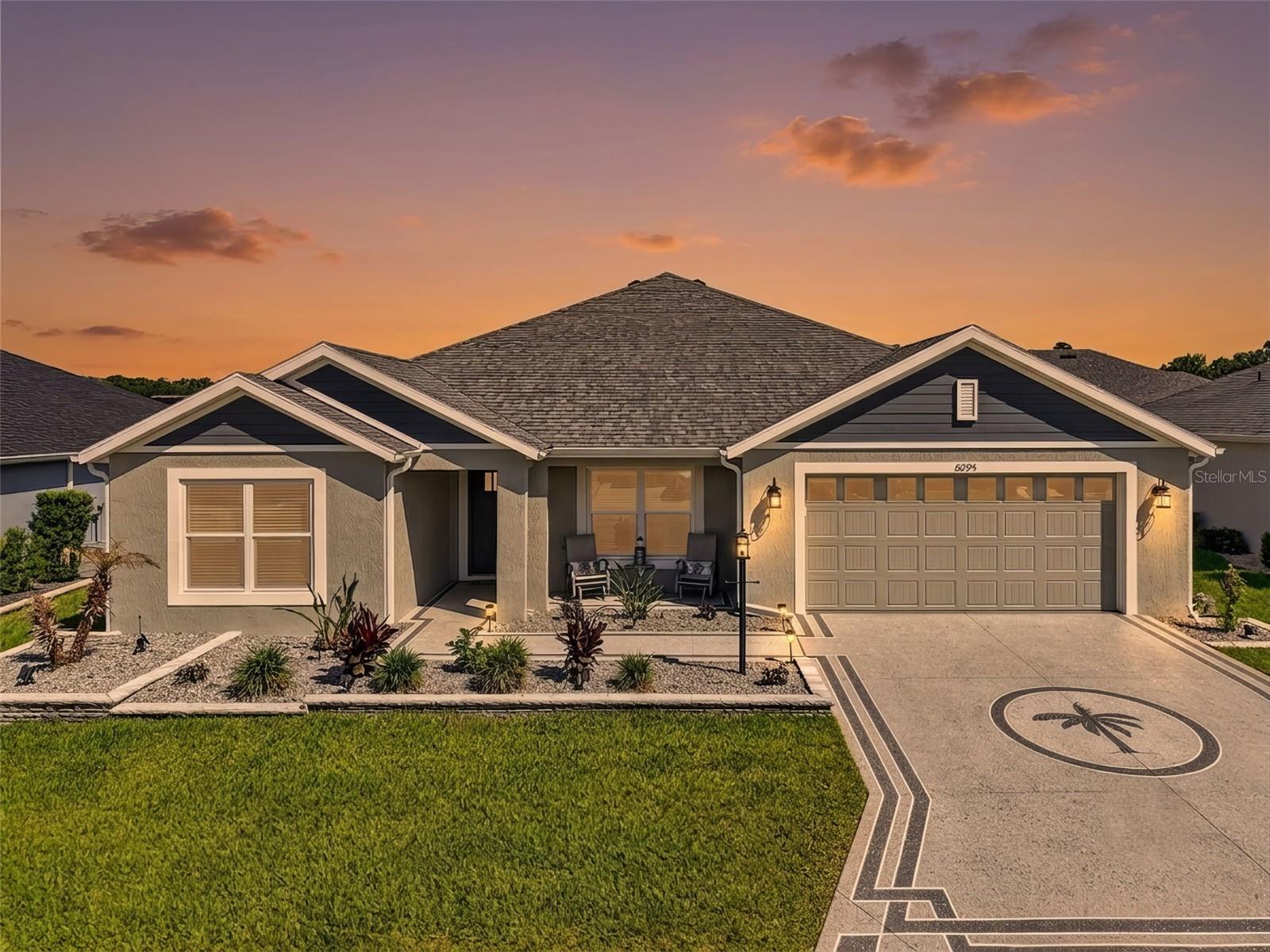 STUNNING, METICULOUSLY-MAINTAINED, BLOCK and STUCCO, 4/2 Designer Hummingbird with EXTRA DEEP 22’x27’ TWO CAR GARAGE and IN-LAW SUITE potential with REAR PRIVACY WALL and ROOM FOR A POOL in the CONTEMPORARY Village of Newell! Offered TURNKEY, this move-in-ready home also includes a 2020 Yamaha golf cart - everything you need to start enjoying The Villages lifestyle immediately! - JUST MINUTES to BOTH Sawgrass Grove and the NEW Eastport Town Square with live nightly entertainment! Built in 2023, this nearly new home offers low-maintenance peace of mind with modern design! Welcoming you are DECORATIVELY PAINTED drive and walkways, ENHANCED TIERED hardscaping, and STONED beds. Step through the entry into a BRIGHT, GENEROUS foyer boasting HIGH ceilings and LUXURY VINYL PLANK that runs seamlessly throughout the main areas. The EXPANSIVE kitchen is a chef’s delight showcasing ALABASTER SHAKER cabinetry, QUARTZ countertops, STAINLESS appliances, GAS cooking, ROLL-OUT SHELVING, TWO built-in PANTRIES along with a SPACIOUS PANTRY closet, and an EAT-IN COUNTER-HEIGHT breakfast bar. HIGH VAULTED CEILINGS and an OPEN-CONCEPT floor plan create a SPACIOUS, VOLUMINOUS atmosphere throughout the main living area, while MULTIPLE WINDOWS and SLIDING GLASS DOORS bathe the home in ABUNDANT NATURAL LIGHT. From this area, step through FOUR-PANEL SLIDING GLASS DOORS and discover your own PRIVATE OUTDOOR RETREAT! The EXPANSIVE SCREENED LANAI provides the perfect setting for morning coffee, evening cocktails, or relaxing with family and friends, while the adjacent REAR PATIO is ideal for grilling, outdoor dining, and enjoying Florida's year-round sunshine! All of this overlooks a LARGE, PRIVATE BACKYARD featuring a REAR PRIVACY WALL and ample room to add a future POOL! Back inside, retreat to your luxurious primary suite boasting a TRAY ceiling, and LARGE WALK-IN closet. Its ensuite bathroom features ALABASTER SHAKER cabinetry with QUARTZ top, DUAL sinks, corner TILED ROMAN-STYLE WALK-IN shower, built-in LINEN closet, and a separate water closet. Near the front of the home, a SPLIT FLOOR PLAN places two additional bedrooms and a second bath behind a POCKET door, creating a potential in-law suite or PRIVATE guest wing. Bedrooms two and three each feature built-in closets. The second bathroom offers an ALABASTER SHAKER vanity with QUARTZ top, TILED WALK-IN shower, and hall LINEN closet.  A fourth bedroom with double windows and a built-in closet, lies across the foyer - ideal for a quiet home office, den, or additional guest quarters. The INTERIOR LAUNDRY ROOM has ALABASTER SHAKER cabinetry with shelving and a built-in UTILITY SINK. Completing the package is an EXTRA DEEP 22’x27’ TWO-CAR GARAGE boasting PLENTY of room for vehicles, golf carts, and storage! DON’T MISS YOUR OPPORTUNITY TO OWN THIS INCREDIBLE HOME! The Village of Newell is close to Sawgrass Grove, Brownwood Paddock Square, and the NEW Eastport Square; 26 miles of walking and biking trails; six neighborhood pools and recreation centers (Franklin, St. Catherine, Bradford, Aviary, Hawkins, Homestead); three large regional recreation complexes (Ezell, Everglades, and Rohan); Southern Oaks Country Club and Championship Golf Course; Clifton Cove Putting Course; Mickylee Pitch and Putt; shopping and dining at Magnolia Plaza; Homestead dog park for your furry friends and more! PLEASE WATCH OUR WALKTHROUGH VIDEO of this MAGNIFICENT  TURNKEY HOME and call today to schedule your Private Showing or Virtual Tour!