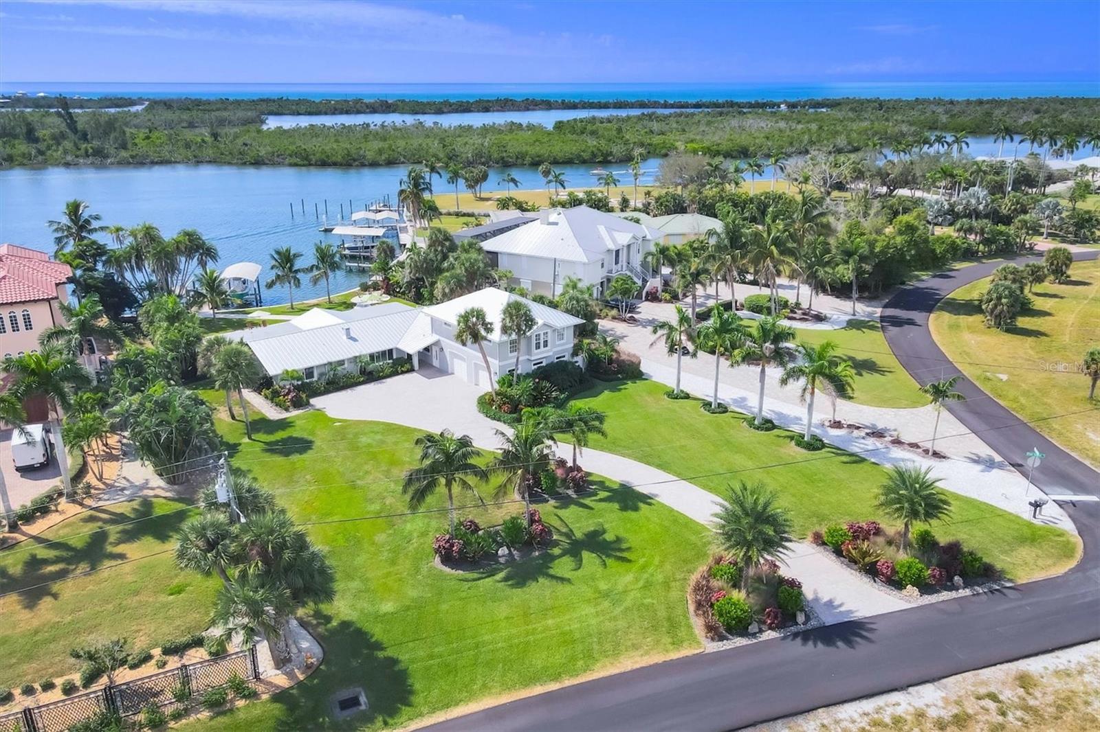 LUXURY ICW ESTATE WITH UNRIVALED BOATING

Live the ultimate Florida waterfront lifestyle from this meticulously renovated 5-bedroom, 3.5-bath retreat located directly on the Intracoastal Waterway (ICW). A boater's dream, this home provides deep water access with no bridges to the Gulf - you can be fishing in the famous Boca Grande Pass or cruising to barrier islands in minutes!

The home is set back on a lush, three-quarter acre lot in the prestigious Cape Haze community. A long paver driveway delivers complete privacy and opens to an expansive lanai and pool deck featuring travertine tiling, a firepit, and nothing but panoramic water views. The pebble-tec pool boasts a heater/chiller for year-round enjoyment.
Boating Infrastructure is Top-Tier: Includes two deep water docks and two upgraded 12,000 lb boat lifts with new motors, aluminum bunks, and durable Trex decking. All docks and seawall caps are newly updated. A cleaning station is adjacent to the slips to prepare the days catch!

Enjoy incredible water views from nearly every room. There is a new 2023 roof, and two newer 2021 air handlers. The kitchen is a chef's delight with granite countertops, stainless steel appliances, a wet bar, and a wine refrigerator.

A thoughtful and private addition was created which is perfect for family or friends. This second floor guest wing features impact-resistant windows, a separate living room, and three vaulted-ceiling bedrooms with a full bath.

Situated on a quiet no-wake zone of the ICW—perfect for kayaking or paddleboarding—this location is minutes from stunning beaches, championship golf, biking paths, and waterfront dining. Offered furnished (with some exclusions) for an immediate transition to your new waterfront life.