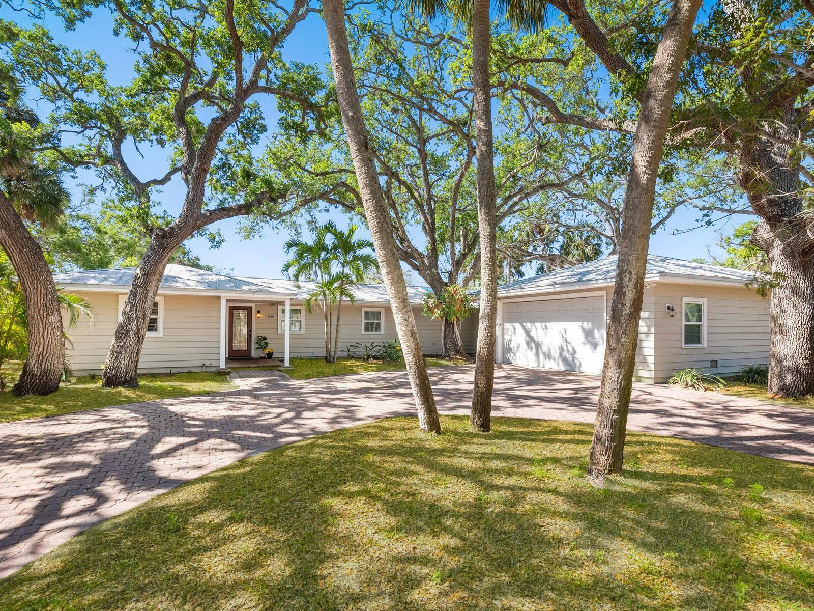 One or more photo(s) has been virtually staged. Siesta Key, island living at its best. Welcome to your waterside home where you’ll enjoy a carefree, tropical lifestyle all year long. This home has been nicely maintained along with an extensive addition completed in 2015. The original home included two guest bedrooms with adjoining Jack and Jill bath plus a primary suite. The 1,200-square-foot addition included an oversized en suite with double sinks and vanity area, walk-in closet, three-headed walk-in shower plus a wall of linen closets. The addition also included a flex room used as an office, plus a 22-by-20-foot pantry/laundry area. A truck-friendly spacious garage with room to accommodate four vehicles and 8-foot high garage door was also part of the expansion. New can lighting installed in living room, dining area and kitchen in 2016 along with a new generous-sized kitchen island. The entire home has low maintenance polished concrete flooring that flows seamlessly throughout. Walls of sliding glass doors surround the oversized screened-in lanai and oversized pool. It’s easy to open up the entire house to the great outdoors when entertaining friends and family. For the boating enthusiast, the home sits on a canal with direct access to the Intracoastal Waterway and offers a 27-foot dock equipped with a 10,000-pound boat lift plus a dual jet ski lift. This home exemplifies the best of island living and don’t forget, world famous Siesta Key Beach is only a short distance away.