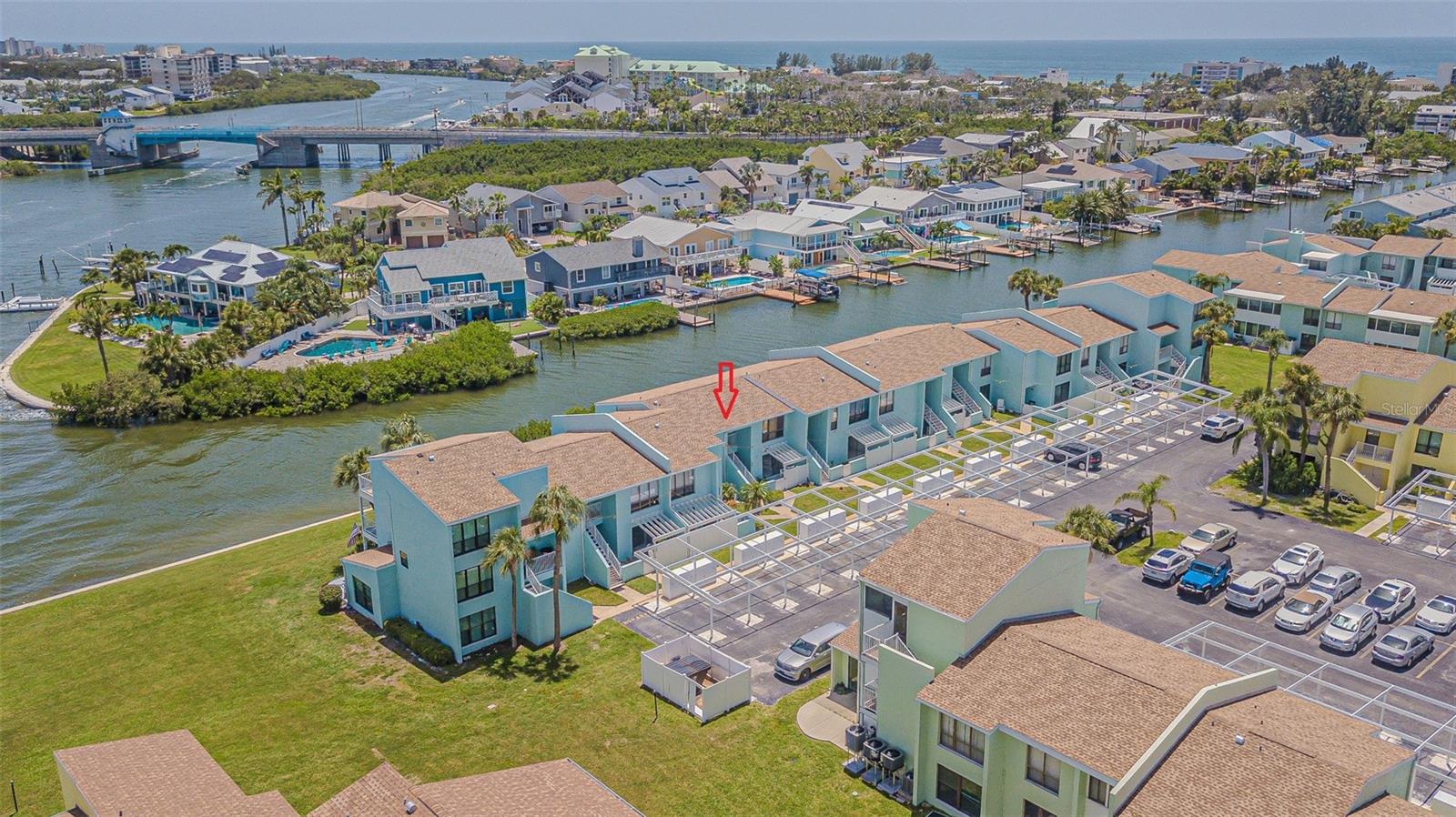 ASSUMABLE LOAN!  3.625% Conventional thru Chase... Fantastic Savings for qualified buyer!  Want a dream coastal getaway in Indian Rocks Beach, just blocks away from the Gulf?  This IS it!  Fully furnished, TURNKEY, Waterfront condo offers the best of Florida living.  This bright and spacious condo is bigger than it looks and offers breathtaking views of the Intracoastal Waterway from the primary bedroom, extended great room, kitchen, and bonus room.  Relax in Casual elegance in this updated 2-bedroom, 1-bath condo, ready for you to move right in! Covered front porch welcomes you to enter thru Double entry doors into the foyer to find a tiled entry and a spacious utility closet. Large windows brings the beauty of the outdoors in and you will be impressed with the casual décor and loads of storage.  Large windows and custom mirror insets bring in natural light and reflects the peaceful, natural water views throughout the home, making the interior feel bright, airy, and serene.  The condo features thoughtful upgrades including durable laminate floors, tile in the entry and bathroom, plus a recently renovated kitchen with white cabinets, granite look countertops and a sleek matte black sink.  The layout includes a cozy dining area with a freestanding electric fireplace, eat-in breakfast nook with built-in bar and bookshelves in the bonus room that can be used as an office, guest space, or reading nook... all while enjoying shimmering water views of the canal with natural Florida Landscape.  You’ll also love the convenience of the in-unit laundry area with energy-efficient washer and dryer, plus recent updates like a newer water heater and roof aid in energy efficiency.  The community offers amenities that make every day feel like a vacation, including a pool, clubhouse, and shuffleboard courts overlooking the Intracoastal.  Whether you're looking for a full-time residence, vacation home, or investment opportunity, this condo delivers relaxed Florida living for lounging indoors or enjoying the coastal breeze outside on the covered front porch.  Close proximity to  charming cafes, specialty shops and the small town of Indian Rocks Beach, nestled between famous Clearwater and St Pete!  Come fall in love with the easy, waterfront lifestyle you've been dreaming of... CALL TODAY!