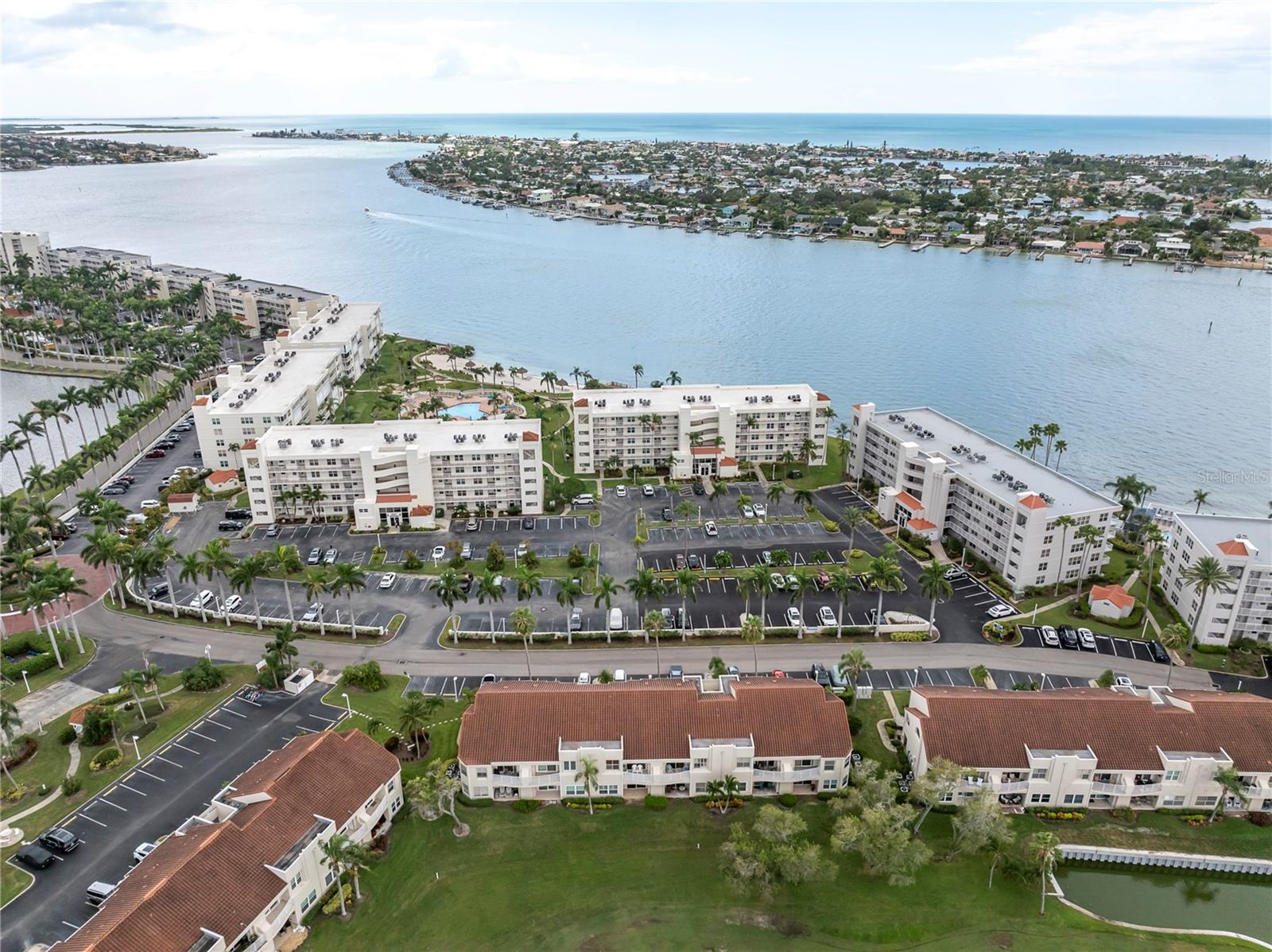 **Short term Rentals Permitted** Experience amazing golf course views looking at the eighth hole at the Isla Del Sol Championship Golf Course from this highly desirable Vista Verde West condo which has an open floor plan and a true split plan for the bedrooms. This beautiful residence combines comfort, style, and exceptional rental potential. The large 18x18 diagonal tile in the main living space makes cleaning easy and  effort free. The kitchen is open and has a convenient breakfast bar, while cooking you can enjoy the open concept of this unit and enjoy time with family and friends.  The spacious primary suite includes a walk-in closet and an en-suite bathroom with a view of the golf course. The guest bedroom also offers a walk-in closet, while the guest bath has a jack and jill bath, the bath doubles as an en-suite bath and guest bath. Additional highlights include a New A/C installed in 2025, covered lanai with a view of the golf course and lake, storage closet, full-size washer and dryer, and assigned parking space #108, which is directly located in front of the condo. This condo comes completely furnished with beautiful furnishings as seen in the photos. Residents enjoy access to the club house, community swimming pool and Jacuzzi overlooking the lake, along with exclusive beach access along the Intracoastal Waterway. With a seven-day minimum rental period, this property offers outstanding flexibility and income potential. Optional club memberships are available at Isla Del Sol Yacht & Country Club, including golf, yacht, tennis, and social packages.The Property sits on Boca Ciega Bay. You are located a few blocks from Gulf beaches including St. Pete Beach and Pass A Grill where the Iconic Don Cesare, the "Pink Hotel", Fort De Soto Park, shopping, dining, and Interstate 275. This is a must see opportunity to enjoy the best of Florida resort style living.