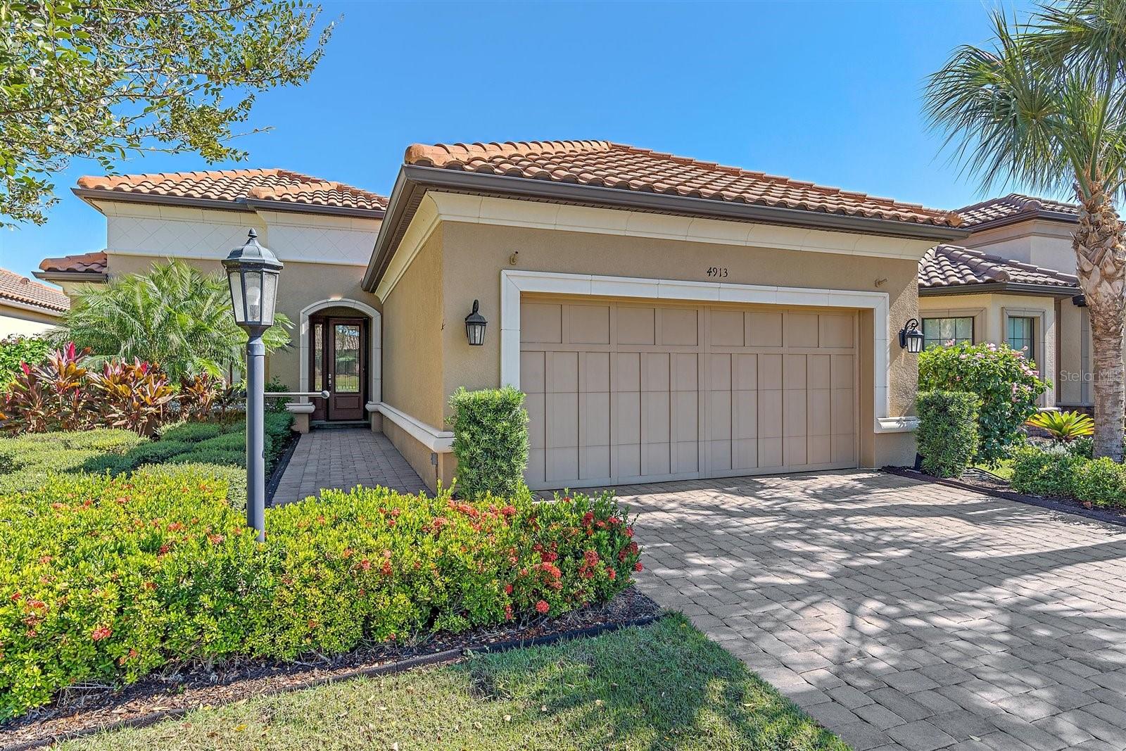 Golf-membership, pool home with a water view! This upgraded, immaculate Farnese model with all the bells and whistles is sure to delight. Throughout you will find high-gloss, oversized tile, 4” plantation shutters, built-in closets, 8’ doors, crown molding, and much more. You have 2 bedrooms with ensuites plus a 3rd flex space for another bedroom, office or den. The dining room also has space-saving pocket doors and can be used alternatively. The kitchen features quartz countertops, extra-large sink, upgraded cabinetry and GE Cafe appliances. The extended lanai is a showstopper - heated salt pool with water features and oversized hot tub, a gourmet kitchen with Kalamazoo multi-fuel grill and oversized hood vent, AV system, fridge, icemaker, an electric awning, and of course water views! Other notable mentions is the 2.5 extended car garage with overhead and wall storage systems, large laundry room with double countertops and large top and bottom cabinetry, whole house central vac and dehumidifier, Lutron light switches, and much more. Esplanade is the place to be ~ enjoy the golf membership, racquet sports, spa, restaurants, community events, and amenities galore.