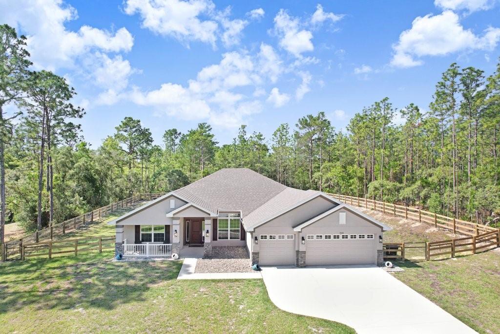 Welcome to this beautifully upgraded home nestled on a spacious 1-acre parcel in the highly desirable Pine Ridge Equestrian Community in Beverly Hills, FL. Whether you're an equestrian enthusiast or simply love wide open spaces, this property is the perfect fit — bring your horses and take advantage of the nearby horse trail entrance just moments from your door! This home offers a wonderfully flexible floor plan designed for both everyday living and entertaining. The separate family and living rooms provide plenty of space for everyone, while the formal dining room and breakfast nook give you options for casual mornings and more formal gatherings alike. The open kitchen features a breakfast bar, generous counter space, and stainless-steel appliances — making it as functional as it is inviting. Step outside through the covered lanai and take in the peaceful surroundings of your fully fenced backyard. The property is enclosed with 3-board agricultural fencing, giving it a classic equestrian aesthetic while providing security and privacy. Gutters and downspouts have been added to protect the home and landscaping year-round. The covered front porch welcomes guests with charm, while the covered lanai in the back is the perfect spot to relax and unwind. And there is a bathroom conveniently connected to the lanai, making it an ideal candidate for a future pool bath.  The primary bedroom is a true retreat, featuring an elegant tray ceiling that adds height and architectural charm, along with spacious walk-in closets that provide all the storage you could ask for. The upgrades continue with tile and waterproof luxury vinyl plank flooring throughout, window blinds, and ceiling fans with lights in all the right places. The built-in TAEXX pest control system provides added peace of mind, keeping the home protected without the hassle of regular exterminator visits. The 3-car garage offers abundant space for vehicles, storage, or even a workshop. This is a rare opportunity to own a truly move-in ready home in one of Citrus County's most unique and desirable communities. Homes like this don't last long — schedule your private showing today before it's gone!