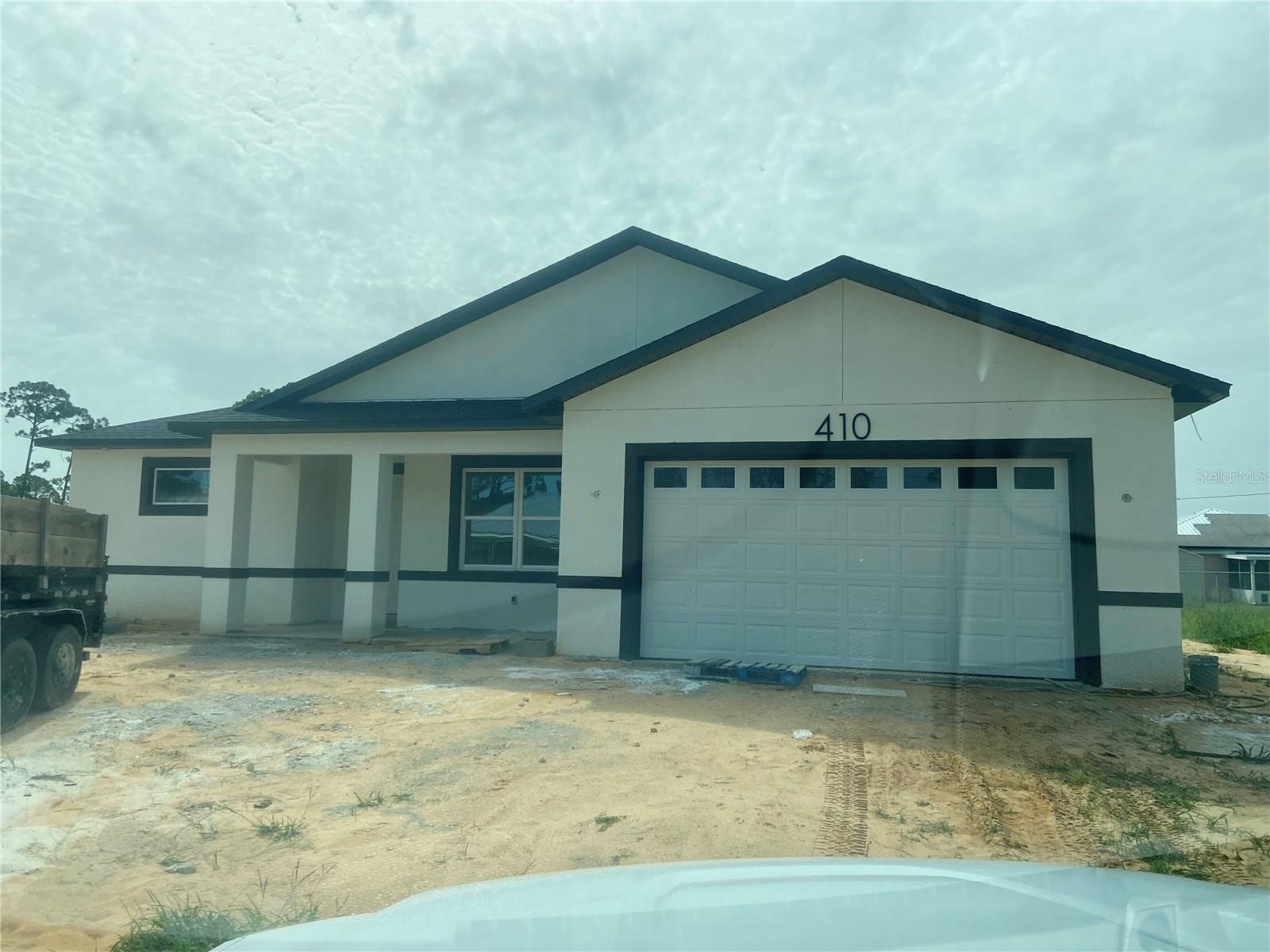Under Construction. Enjoy all that Sebring is known for—beautiful lakes, outdoor recreation, historic charm, and a community spotlighted by HGTV. A rare opportunity to own a thoughtfully designed new construction home in one of Central Florida’s most desirable and welcoming towns. Under construction BLOCK home in the heart of Sebring in the desirable area of Sebring Country Estates.   Split floor plan, 3/2/2. Covered front porch is 17’X 5’. Open concept with great room featuring tall ceilings & recessed LED lighting.  All ceiling are 9 ft high.  Home features, porcelain tile in all wet areas & laminate wood in all other areas.  Spacious kitchen opens to great room. Kitchen features granite counter tops, stainless steel appliances, built-in microwave and a walk-in pantry. The kitchen island, features a  farm house deep sink & dishwasher.  The great room has double doors that opens to your covered/screened lanai of 36’ in length and 10’ wide. Master Suite is spacious and prewired for a ceiling fan, features an in-suite walk in closet of 9’X8’. Also features an in-suite master bath with double vanities, granite vanity tops, a walk in ceramic tiled shower, private water room and lien closet. The other 2 bedrooms are located on the other side of the home. Bedrooms have mirror sliding closet doors. There is a full bath off the kitchen area and adjacent to bedroom #3.  This bath has granite vanity top & a tiled tub/shower combo. Home has a double garage with attic access & a smart automatic garage door opener and LED recessed lights. The laundry area & pantry is located as you come in from the garage making it so convenient to stock you groceries.  The yard features an irrigation system. You have space for your fire pit & entertaining on your large covered/screened lanai.  Minutes from Walmart, Walgreens, Publix, hospitals, South Fl State College, Nucor & US Hwy 27. Sebring International Raceway is 13 miles, approximately 70 miles from Punta Gorda Airport, 80 south of Orlando International Airport, 97 miles south of Tampa International Airport , 160 miles from Miami and about 70 miles to east or west coast of Florida.  We are in Highlands County.
