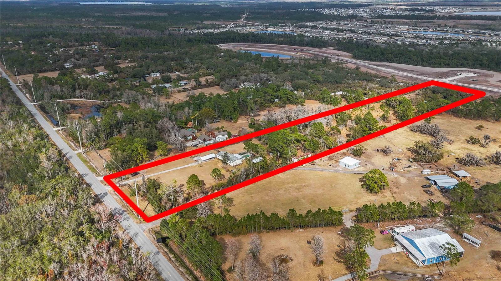 One or more photo(s) has been virtually staged. ATTENTION DEVELOPERS & BUILDERS!!! HUGE PRICE DROP on this PRIME 5.85-acre DEVELOPMENT opportunity in the heart of fast growing St. Cloud, Florida 5 minutes from LAKE NONA!  Adding immediate value is a large, well-kept MOBILE HOME  that is surprisingly spacious and charming inside, complete with a private pool , perfect for living on-site or generating rental income while you plan, permit, or build. This HIGH and usable land sits directly in the path of expansion where new construction and builder activity are happening at record pace , making this an exceptional investment for builders, developers, or families seeking space to create a private compound! Utility MAP AVAILABLE!   With utilities nearby and ample road frontage, the property offers incredible flexibility for a small residential development, custom home sites, or a luxury estate with room for guest homes, workshops, RV/boat storage, or multi-generational living. Possibilities are Endless here!! Acreage this close to town that is zoned for INCREDIBLE Schools, close to amazing shops, and major roadways is becoming increasingly scarce. Whether you’re a builder ready for your next project or a family dreaming of land and freedom without sacrificing convenience, this property checks every box!!  Land, location, and limitless potential ! Opportunities like this don’t last.
