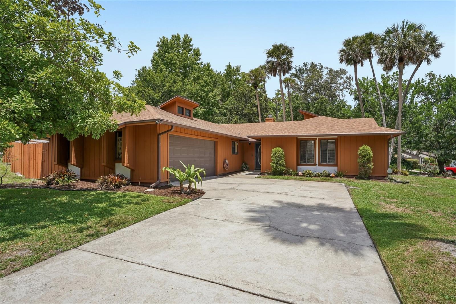 Welcome home to this charming 4-bedroom, 2-bath residence nestled on a spacious corner lot in the highly desirable Highlands community of Winter Springs. From the moment you arrive, you'll appreciate the inviting curb appeal, mature surroundings, and move-in ready condition that make this home truly special.

Inside, vaulted ceilings and abundant natural light create an open and airy atmosphere, while updated flooring adds a fresh, modern touch throughout. The heart of the home features a cozy wood-burning fireplace, perfect for gathering with family and friends. The kitchen is both stylish and functional, offering beautiful wood cabinetry, granite countertops, and stainless steel appliances.

The thoughtfully updated bathrooms provide comfort and convenience, while sliding glass doors from the living room lead to an expansive covered and screened patio—an ideal space for morning coffee, weekend barbecues, or simply relaxing and enjoying Florida's beautiful weather. The partially fenced backyard offers plenty of outdoor space, complete with a storage shed for tools, hobbies, or seasonal items.

Located within The Highlands, residents enjoy access to exceptional community amenities including a swimming pool, playground, and tennis courts. Conveniently situated near shopping, dining, parks, and major highways, this home offers the perfect blend of comfort, convenience, and community. Don't miss your opportunity to make this wonderful Winter Springs home your own!