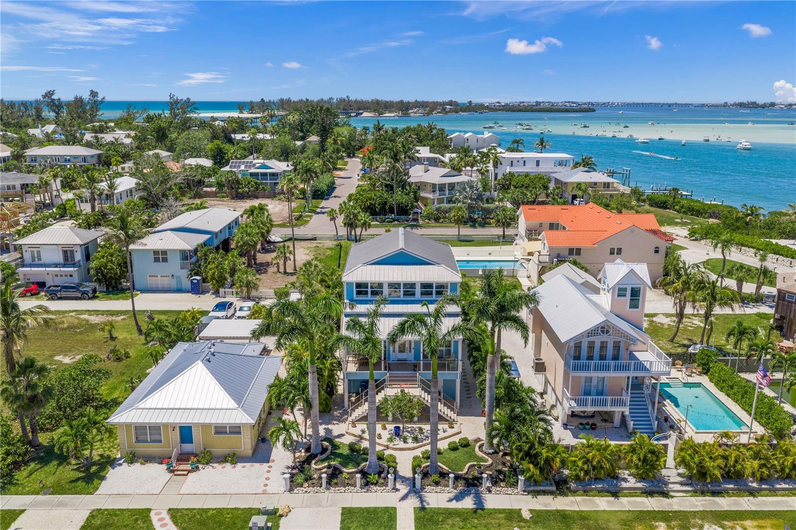 Welcome home to 791 Broadway, nestled in the heart of historic Longbeach Village on the North end of prestigious Longboat Key. This elevated island-style residence offers the perfect blend of coastal charm, comfort, and relaxed island living. Thoughtfully designed across multiple levels including a large 11x30 third floor FLEX SPACE that could easily be converted into a 3RD BEDROOM. This home captures beautiful morning sunrises, colorful sunsets, and stunning views of Sarasota Bay and the intracoastal waterway. From the moment you step inside, you are greeted by an abundance of natural light, soaring ceilings, plantation shutters, and inviting open spaces that are ideal for both everyday living and entertaining. The property offers wonderful flexibility, including an oversized garage with plenty of room for golf carts, kayaks, bicycles, beach gear, and more. The outdoor living areas are equally inviting, with several unique spaces to relax and enjoy the surroundings — from the covered front porch to the rear deck overlooking the water, along with the peaceful sound of multiple water features throughout the property. Recent updates add comfort and peace of mind, including new impact-resistant and energy-efficient windows, two AC units, updated flooring, and many additional improvements that make this home feel warm, welcoming, and move-in ready. Enjoy the charm and convenience of the Village, just a short stroll from community fishing piers, a boat launch, exceptional dining, and the white sandy beaches and turquoise waters of the Gulf of Mexico. This is a wonderful opportunity to experience the laid-back Longboat Key lifestyle in one of the island’s most beloved neighborhoods.