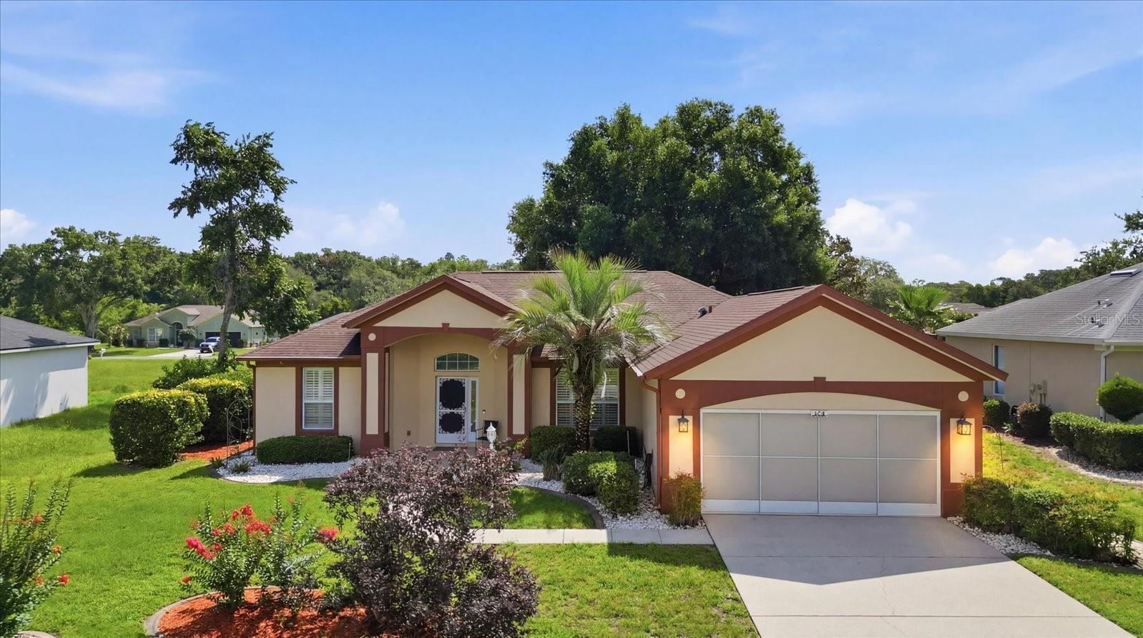A HOME IS A STARTING PLACE OF LOVE, HOPE AND DREAMS! Well, here is YOUR starting place! This delightfully charming 2BD/2BA, 1,668sqft home sits on .22-acres and is tucked away on a quiet street at the back of the distinguished and active Laurel Ridge Community. Upon approach, the street-side charm is evident with the inviting covered front entry with decorative storm door and side light, tiled floor and the fully landscaped yard featuring decorative curbing, landscaping rocks and irrigation system; while the artistic flair of the exterior trim gives a POP! Once inside versatility abounds where both formal and casual living can be realized. Need to impress, enjoy the formal dining room with plantation shutters and living room with a 3-panel stacking slider that opens to not only an enclosed sunroom for morning coffee or evening read, but a separate screened lanai for expanded entertaining space or family cookouts. A freshly painted kitchen with solid surface countertops, plenty of cabinetry, NEW white subway tile backsplash, breakfast bar and pantry closet is sure to make the cook of the house happy. For day to day, a light and bright nook with a slider to the sunroom and a separate family room is sure to provide plenty of casual comfort for family and friends. The split floor plan allows for plenty of privacy for all! On one side of the home the master bedroom features a slider to the sunroom, dual closets, a 3rd closet for convenience and a freshly painted ensuite with separate, dual sinks, tiled shower and private water closet; while the guest bedroom and bathroom have a hallway all their own on the other side of the home. Electric retractable blinds on the living room and master sliders, the alarm system, and garage screen are all a plus! NO FLOOD ZONE! The Twisted Oaks Golf Course known for its uniquely sculptured course with rolling landscape, sloping greens and strategically placed twisting oaks surrounds the community, while the community pool and clubhouse are the gathering spots for neighbors who have become friends. Conveniently located, less than 3 miles from the Beverly Hills Community Park, The Boys & Girls Club, public library, Lake Beverly and medical facilities. Shopping at Citrus County’s BRAND-NEW RETAIL HOTSPOT, The Shoppes at Black Diamond is only 10 minutes away and all the rave! A FREE 1-year HOME WARRANTY for peace of mind is OFFERED to the Buyer!
