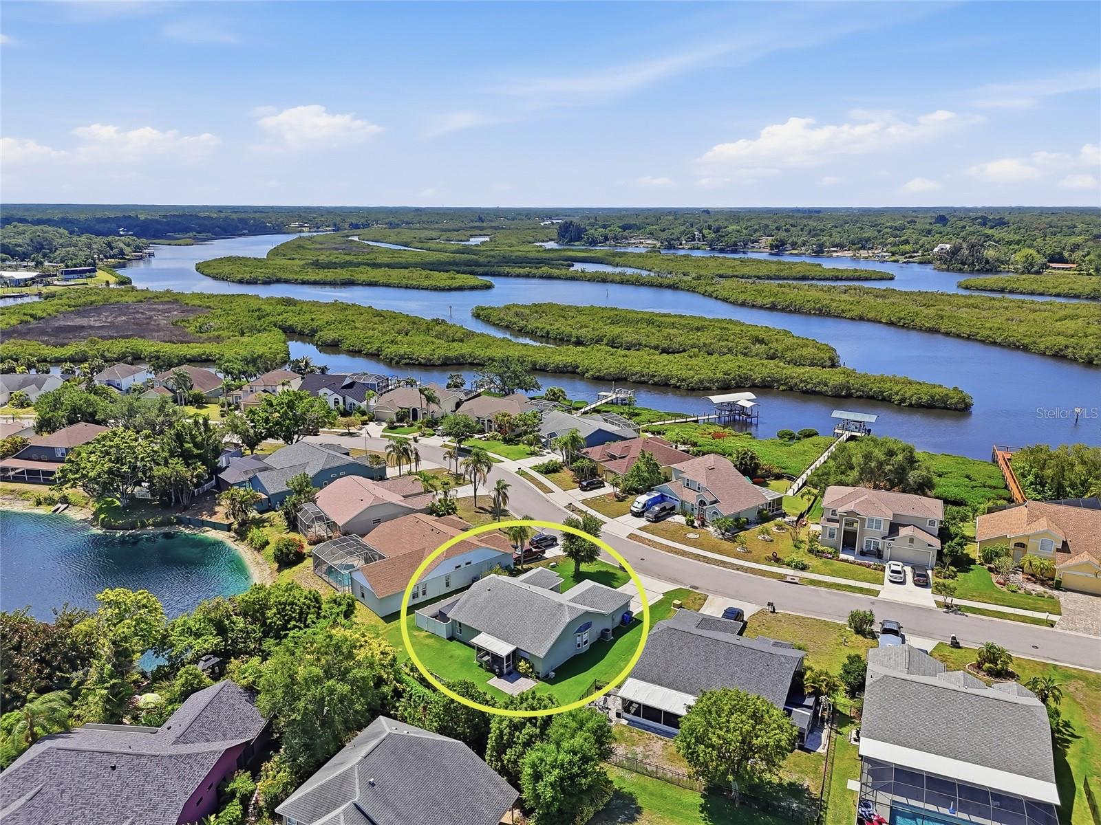 This home qualifies for a 1% lender incentive when using the preferred lender. Live just across the street from the waters of the Braden River in one of the most desirable locations within the Braden River Lakes waterfront community! This beautiful home is situated on one of the community’s premier streets and is within walking distance to the waterfront amenities such as the community pool, tennis and volleyball courts, gazebo, BBQ area, playground, and kayak launch station. Updated and move-in ready, this 3-bedroom, 2-bath home offers partial water views from the backyard and lanai, along with the added benefits of NO flood insurance requirement, NO CDD fees, and a LOW HOA of just $467 per year. Major mechanical updates provide peace of mind, including a 2018 ROOF, 2021 A/C system, tankless water heater, and newer LVP flooring installed in 2024. As you enter the home, you are welcomed by soaring cathedral ceilings, an open floor concept, and an abundance of natural light that creates a bright and spacious atmosphere. The expansive custom-designed kitchen, updated in 2023, is a true centerpiece of the home and crafted for both everyday living and entertaining. It features top-of-the-line stainless steel appliances, an induction stove, granite countertops, a chef’s island, soft-close cabinetry, and a stunning custom wall of cabinets extending into the dining area for exceptional style and storage. A custom walk-in pantry provides even more abundant storage space. The primary suite is designed to impress like a model home retreat, featuring a custom walk-in closet, a custom textured mural wall, sliding door access to the screened lanai, and a beautifully upgraded en-suite bathroom with an expansive glass-enclosed walk-in shower, new toilet, updated fixtures, and a clean, bright modern feel. French doors open to a fully enclosed screened lanai overlooking serene lake and garden views, creating a peaceful and private setting to relax morning or evening. Just outside, a paver patio offers the perfect space for BBQs, entertaining, and outdoor gatherings. Additional highlights include a 9-zone sprinkler system, hurricane-impact garage door, storm shutters with plywood protection, and two storage sheds within a fenced area on one side of the home. Centrally located in the quiet community of Braden River Lakes, where many common areas overlook the water, you can even spot dolphins and manatees right from the community area. Close to all essentials, including dining, banks, and popular shopping destinations such as Publix, Walmart, Costco, Home Depot, and more. Only 3 minutes from the public boat ramp and 20 minutes from the sandy beaches of Anna Maria Island.