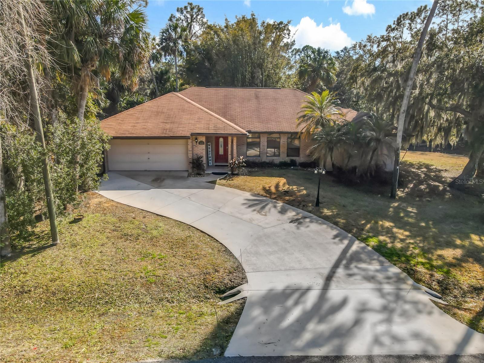 NEW LOWER PRICE IN BEAUTIFUL STONE ISLAND - 193’ ON CANAL - .64 ACRE - BOAT TO LAKE MONROE! - NEW ROOF June 1!
Super floorplan ideal for casual waterfront living. A true GREAT room - 800 SF open area with kitchen, dining and great room leading out to the 25’ screened porch, paver patio and HUGE yard. The kitchen has glazed wood cabinetry, granite counters, dining bar with seating for 6  and stainless appliances.High ceilings, large windows, and glass doors leading to the patio flood the home with natural light and enhance the sense of openness. 
Split floor plan with three bedrooms and two full bathrooms affords the most active family privacy. The spacious 2 room primary suite is a true retreat, opening through French doors and offering a cozy seating area with glass doors leading directly to the back patio. Just off the primary suite is a large bonus room—ideal for a home office, nursery, fitness room, or expansive dressing space—also featuring private access to the patio. The primary ensuite bathroom includes double vanities, soaking tub, a walk-in shower, and a walk-in closet.
The secondary bedrooms and full guest bathroom are situated off the main living space, with the guest bath offering direct access to the backyard. The 12’ laundry room, complete with cabinetry, is conveniently located off the main living space and provides access to both the garage and the exterior.
The oversized lot features mature landscaping and ample space for boat and RV parking. The screened-in back porch showcases Spanish tile and offers serene views of the canal. Just beyond, a  paver patio creates the perfect outdoor entertaining and living space. The backyard is partially fenced, providing flexibility for pets. 
Well maintained AC new in 2025 and water saving sprinkler runs from canal. 

Stone Island is a rare Florida gem nestled along Lake Monroe, part of the St. Johns River. This unique community is known for its large oak trees and peaceful setting. Including pickleball courts, acres of parks and recreational space, a private boat ramp and dock, horse stables(for a fee), and golf-cart-friendly roads. Located just minutes from everyday conveniences and the popular Rails-to-Trails bike path. EVERYONE LOVES STONE ISLAND!