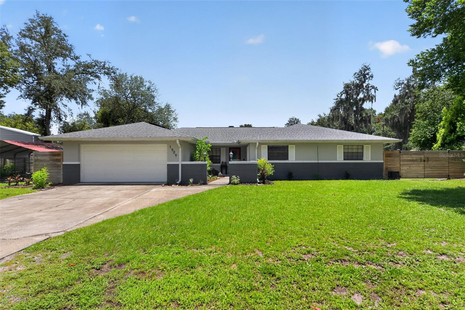 Discover the perfect blend of privacy, space, and convenience at this beautiful home in Deltona. Nestled on nearly one acre with NO HOA, this beautifully maintained 3-bedroom, 2-bath home offers a peaceful, secluded setting while remaining just a short drive from Orlando’s world-famous attractions, shopping, dining, and Florida’s stunning Atlantic beaches.

The expansive property provides endless possibilities, featuring a huge front yard, abundant parking, a long driveway, and an attached 2-car garage. A fenced backyard leads to a spacious deck and enclosed lanai, creating the perfect space to relax and enjoy the tranquil surroundings. One of the property’s standout features is the impressive 36’ x 28’ detached metal 4-car garage/workshop, ideal for car enthusiasts, hobbyists, RVs, boats, recreational vehicles, or extra storage.

This move-in-ready home has been thoughtfully updated with major improvements, including:
New roof & solar panels (2022)
New HVAC (2020)
New water lines (2020)
New electric water heater (2026)
Kitchen appliances, washer & dryer (2020)
Halo whole-home water filtration system (2021)
Gazebo (2024)

If you’ve been searching for a home with room to spread out, NO HOA restrictions, exceptional garage space, and a serene country feel without sacrificing convenience, this Deltona gem is a must-see!
