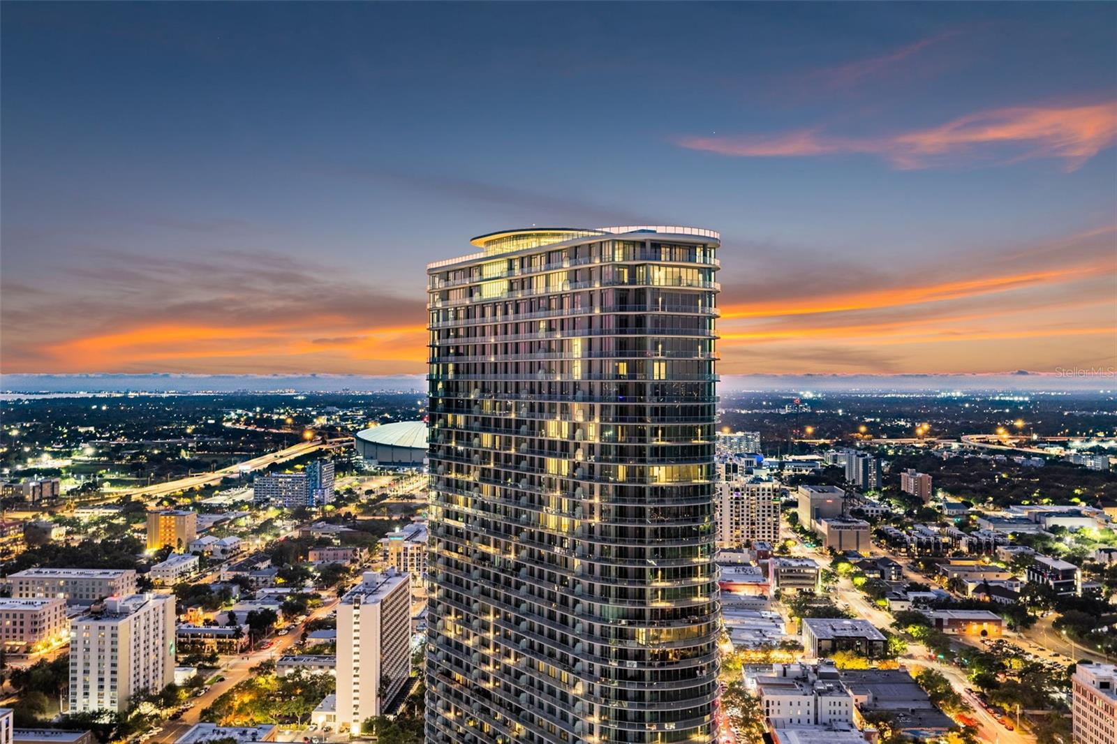 One or more photo(s) has been virtually staged. Ascending on the 37th floor of 400 Central - the tallest residential tower on Florida’s Gulf Coast - Residence 3706 delivers an unmatched pinnacle experience in downtown St. Petersburg. This rare three-bedroom, three-bath sky home combines one of the building’s highest private elevations with approximately $28,000 in thoughtful designer upgrades, creating a turnkey residence that feels custom from the moment you step inside.
 
Spanning approximately 1,948 square feet of sun-drenched interior space plus a sweeping 413-square-foot terrace that runs the full width of the unit, the home invites effortless indoor-outdoor living. Dramatic 10-foot ceilings and walls of floor-to-ceiling glass frame ever-changing views of Tampa Bay, the glittering downtown skyline, and golden Gulf sunsets that paint the horizon each evening. The open-concept great room flows seamlessly into the dining and kitchen areas, where an oversized island equipped with a wine cooler serves as the heart of the space, ideal for casual mornings or sophisticated entertaining while keeping the water views front and center.
 
A smart split-bedroom layout ensures privacy and flexibility. The generous primary suite features direct terrace access, a walk-in closet, and a spa-like bath elevated with Italian tile, custom backsplashes, dual vanities, upgraded medicine cabinet with integrated light, a deep soaking tub, and a frameless glass shower. Both guest suites are thoughtfully proportioned for comfort, whether welcoming family or friends. In the chef-inspired kitchen, premium finishes shine through: light-toned wide-plank wood cabinetry, quartz countertops, European-style detailing, and high-end appliances including a gas range - upgrades that set this residence apart and add immediate value.
 
Beyond the private spaces, 3706 includes dedicated parking (with secure key-fob access and EV charging capability), a private climate-controlled storage unit, and valet service for ultimate convenience. Residents of 400 Central enjoy a full suite of resort-caliber amenities: a resort style pool and spa deck with private cabanas, a state-of-the-art Technogym fitness center complete with yoga and functional-training studios, a residents’ lounge, game room, co-working spaces, boardroom, and the exclusive 46th-floor Sky Lounge with its panoramic observation terraces. A 24-hour concierge, on-site retail and dining, and effortless walkability to Central Avenue’s vibrant scene, world-class museums, waterfront parks, the St. Pete Pier - and even a Michelin Guide restaurant just across the street - complete this one-of-a-kind lifestyle.
 
At 2,361 total square feet including the terrace, Residence 3706 is more than a home - it is an elevated statement of refined coastal living in the heart of downtown St. Petersburg. Move-in ready and truly distinctive.