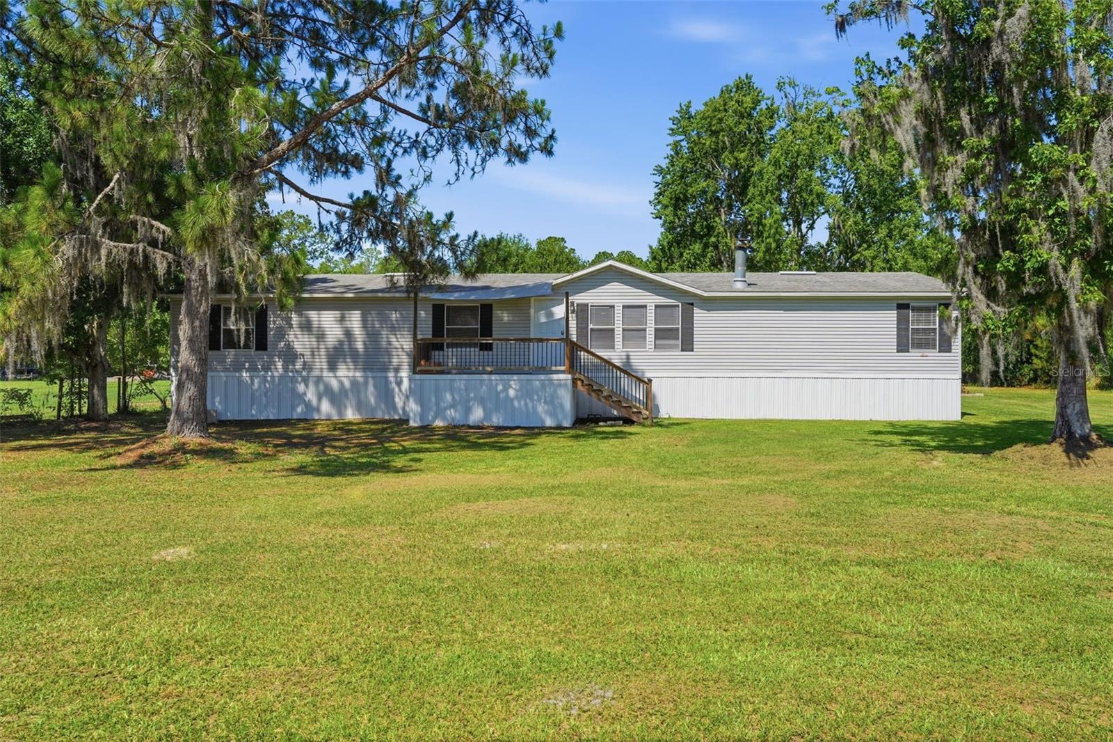 Peaceful Country living with SPACE, Flexibility and PRIVACY, the perfect Balance. This well-maintained 4Bedroom 2.5Bath Home on over 6 Acres features a HUGE open floor plan that creates a warm and inviting atmosphere, ideal for both everyday Living & Entertaining. A Beautiful wood-burning Fireplace keeps you cozy while durable Luxury Vinyl flooring throughout the home gives it a clean, modern look. This Kitchen, well it's a COOKS Dream with a HUGE island, lots of granite countertops, stainless steel appliances and plenty of Cabinetry reflecting the Heart of the Home. Your Primary Retreat has his/hers walk-in closets with an on-suite Bathroom while the additional 3Bedroom are far across the other side of Home giving true meaning to split plan and privacy. Also, Outside the Property truly shines where You'll LOVE the oversized rear deck overlooking the expansive back of Property ideal place for relaxing mornings, weekend gatherings, or simply enjoying the beauty and privacy. There's plenty of room for your Garden, raising some animals, ALL those fun Toys along with more SPACE to let the imagination run wild with ALL the endless possibilities of this Property. Surround yourself with comfort knowing all the major items have been taken care of 3yr old Roof, 3yr old AC, updated Electrical & Plumbing 2024, 2yr old Well Pump and Water Softener system and new Siding & Metal Framing 2025.
Location is PERFECT and far enough out that the ICE CREAM won't melt but still conveniently close to major roadways making commutes to surrounding areas a breeze. This property is more than just a home, it's a Lifestyle surrounded by SPACE, COMFORT & SERENITY. Don't miss the opportunity to make it yours.