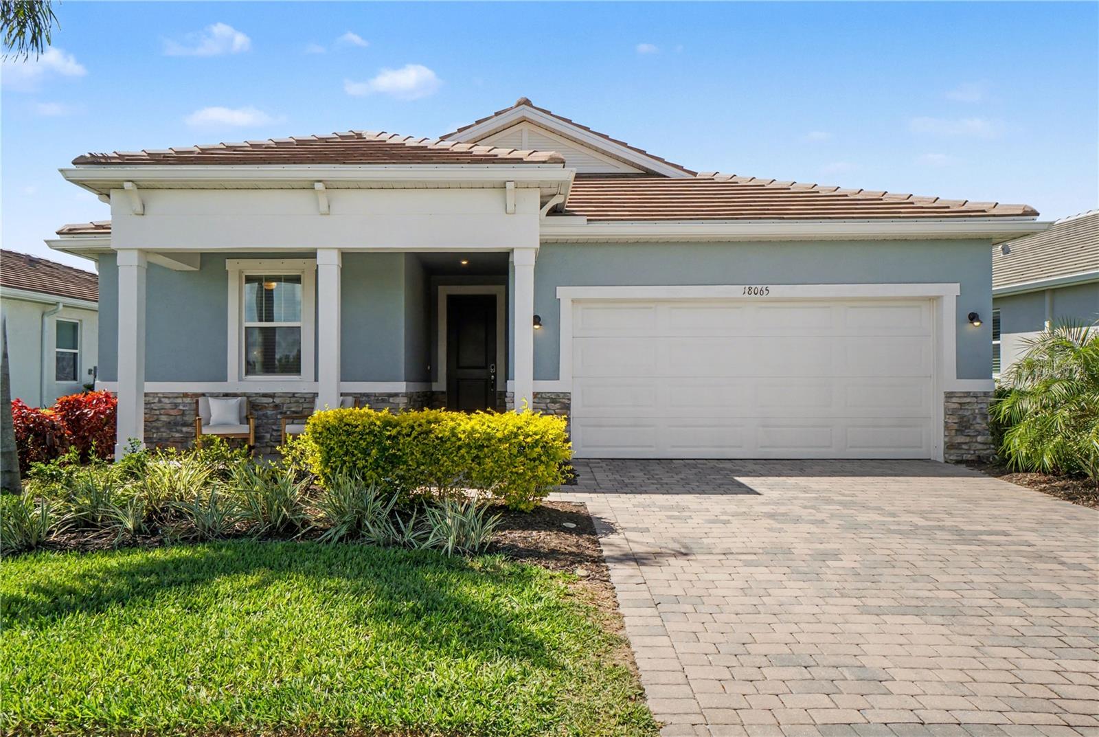 Welcome to this beautifully designed 4-bedroom, 3-bath Mattamy home located in the highly sought-after Sunstone community of Wellen Park. Offering the perfect blend of style, comfort, and functionality, this residence is being offered optionally furnished—making it truly move-in ready or ideal as a seasonal retreat. From the moment you arrive, you’ll appreciate the inviting curb appeal with a paver driveway, charming front porch, and tasteful coastal architecture. Inside, the home opens to a bright and airy layout featuring wood-look flooring, neutral tones, and an abundance of natural light throughout. The heart of the home is the stunning open-concept kitchen, complete with quartz countertops, modern white cabinetry, tile backsplash, stainless steel appliances, a spacious island with seating, and designer pendant lighting. The kitchen flows seamlessly into the dining area and great room, creating an ideal space for entertaining or everyday living. The thoughtfully designed split floor plan offers privacy and flexibility, with a spacious primary suite featuring serene views, a large walk-in closet, and a well-appointed en-suite bath. Two secondary bedrooms with bath and an extra guest ensuite provide ample space for family, guests, or a home office.
Step outside to enjoy peaceful preserve views from the covered lanai—perfect for morning coffee or evening relaxation. Located just minutes from the vibrant downtown Wellen Park area, you’ll have easy access to waterfront dining, shopping, entertainment, and community events. You’re also a short drive to Venice Island, where you can explore charming boutiques, restaurants, and some of Southwest Florida’s most beautiful Gulf beaches. Whether you’re looking for a full-time residence, vacation home, or investment opportunity, this exceptional property offers the best of Florida living in one of the area’s fastest-growing communities.