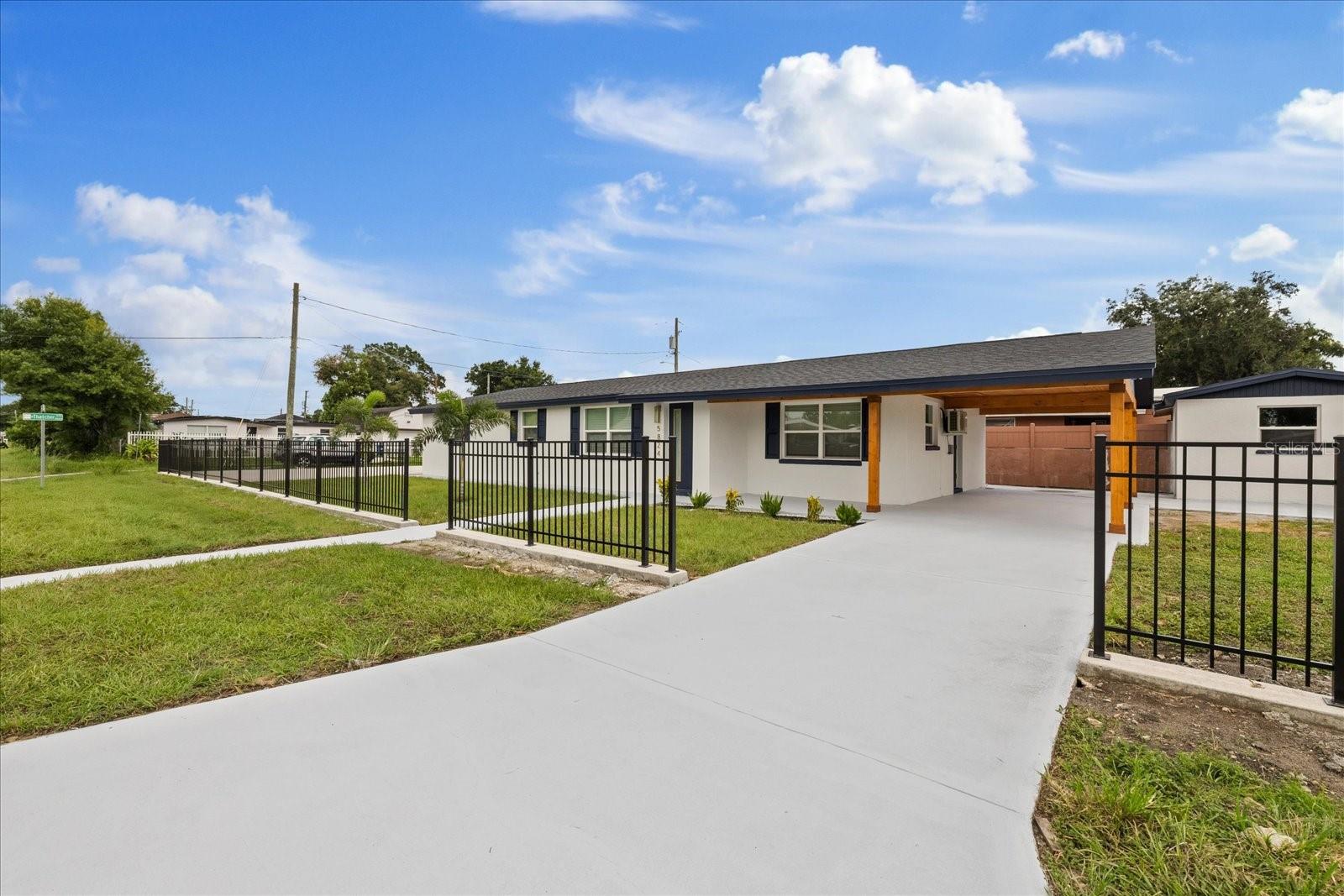 Welcome to this beautifully renovated corner-lot home in one of Tampa's most convenient and desirable locations! Offering over 1,900 square feet of thoughtfully updated living space, this exceptional property combines modern style, flexibility, and income-producing potential.

The spacious main residence features 3 bedrooms, 2 beautifully renovated bathrooms, an open and inviting layout, a dedicated inside laundry room, and stylish finishes throughout. Every detail has been carefully updated, creating a move-in-ready home you'll love.

A standout feature is the private mother-in-law suite with its own separate entrance, offering an additional bedroom and bathroom—perfect for extended family, guests, a home office, or rental income opportunities.

Step outside to enjoy the concrete patio, ideal for entertaining or relaxing, along with a carport, storage space, and an oversized parking area with plenty of room for multiple vehicles, boats, or recreational equipment.

Enjoy the benefits of a prime corner lot with excellent curb appeal and convenient access to shopping, dining, major highways, Downtown Tampa, Tampa International Airport, schools, and more.

For added peace of mind, the home's major systems and big-ticket items have also been updated, making this an exceptional turnkey opportunity. Don't miss your chance to own this versatile, fully renovated property in a fantastic Tampa location—schedule your private showing today!