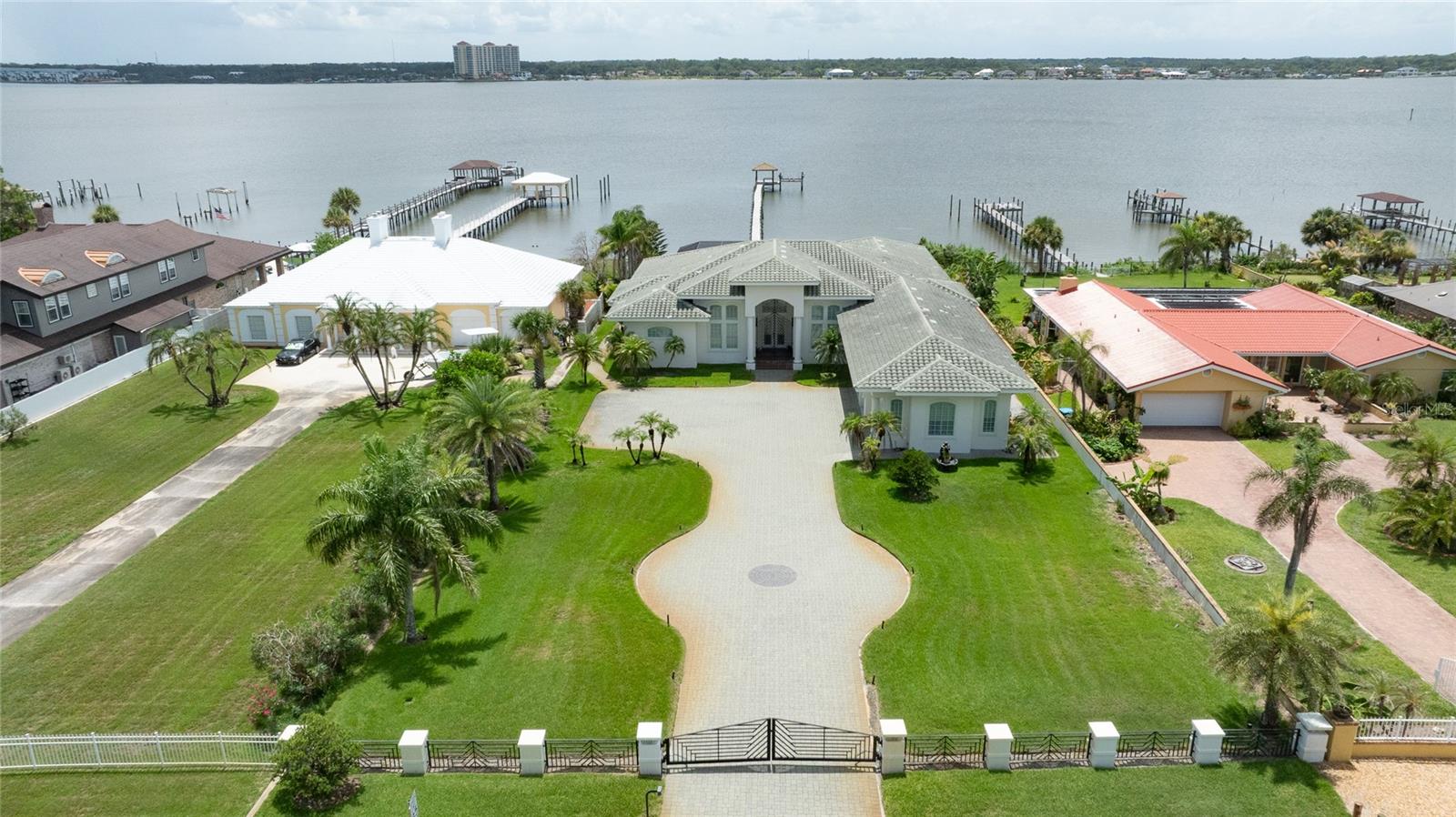 A stunning luxury estate on the river is now available. This contemporary home features over 5,400 square feet of living area designed to balance modern style with comfort. The gated property sits on a deep lot (100x326) with a paver driveway and an oversized 3-car garage. The interior is divided into two wings: - The Private Wing: A secluded primary suite with a luxury bathroom features a modern design including two vanities, two separate shower heads, a rain shower head, a tub, walk-in closets and a sitting area with a double fireplace overlooking the river. - The Guest Wing: Three additional bedrooms, each with a private full bath, an extra half bath, and a laundry room. The home also includes a grand foyer, formal living and dining rooms, a bar, and an open island kitchen. Large windows throughout the living areas offer gorgeous views overlooking the screened pool, spa, summer kitchen, and river where you can watch dolphins swim by the dock and enjoy spectacular sunsets.

The property comes fully furnished with a boat dock & boat lift. All information intended to be accurate but cannot be guaranteed.