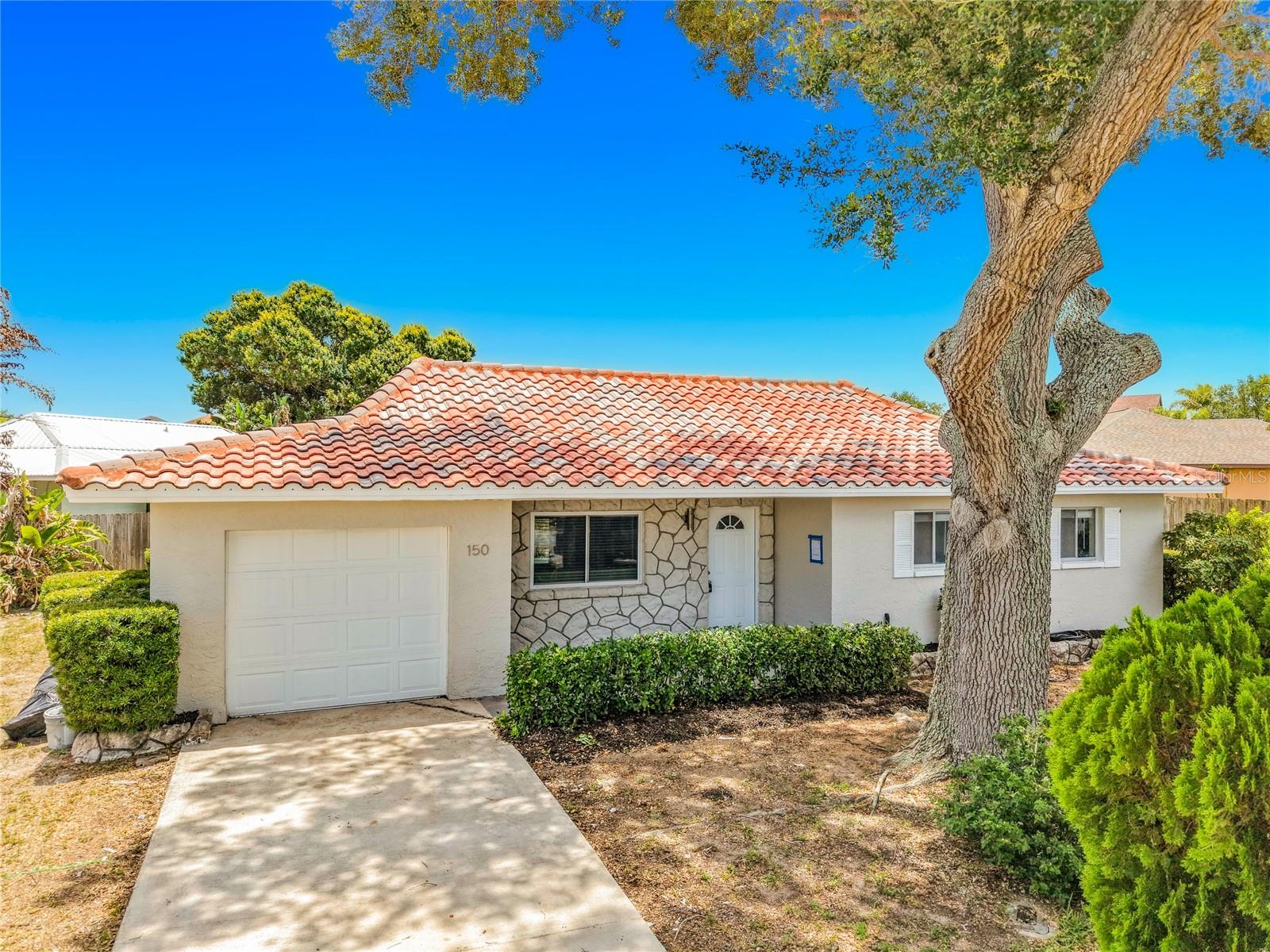 This beautifully renovated, move-in-ready 2-bedroom, 2-bathroom home offers modern living in a peaceful, established neighborhood. The property has been updated with high-quality finishes, starting with a brand-new kitchen featuring soft-close white wood cabinetry, pristine quartz countertops with a breakfast bar, and a complete stainless-steel appliance package. The bright interior boasts durable new Luxury Vinyl Plank (LVP) flooring, fresh interior and exterior paint, a new front door, updated light fixtures, modern ceiling fans, and upgraded door hardware throughout. Essential systems provide total peace of mind with a brand-new HVAC system, a new water heater, and updated plumbing, alongside a clean, newly painted garage floor. Designed for low-maintenance coastal living, the home features a spacious, fully fenced backyard and a private, screened and covered back porch perfect for relaxing. The prime location sits just minutes from Cocoa Beach and the Intercoastal Waterway, offering easy access to top-rated schools, local shopping, dining, and entertainment. Perfect for aerospace and military professionals, the property provides a short commute to Patrick Space Force Base, Port Canaveral, Kennedy Space Center, NASA, SpaceX, and Blue Origin, while remaining just 45 minutes from the Orlando International Airport (MCO) and area attractions.
