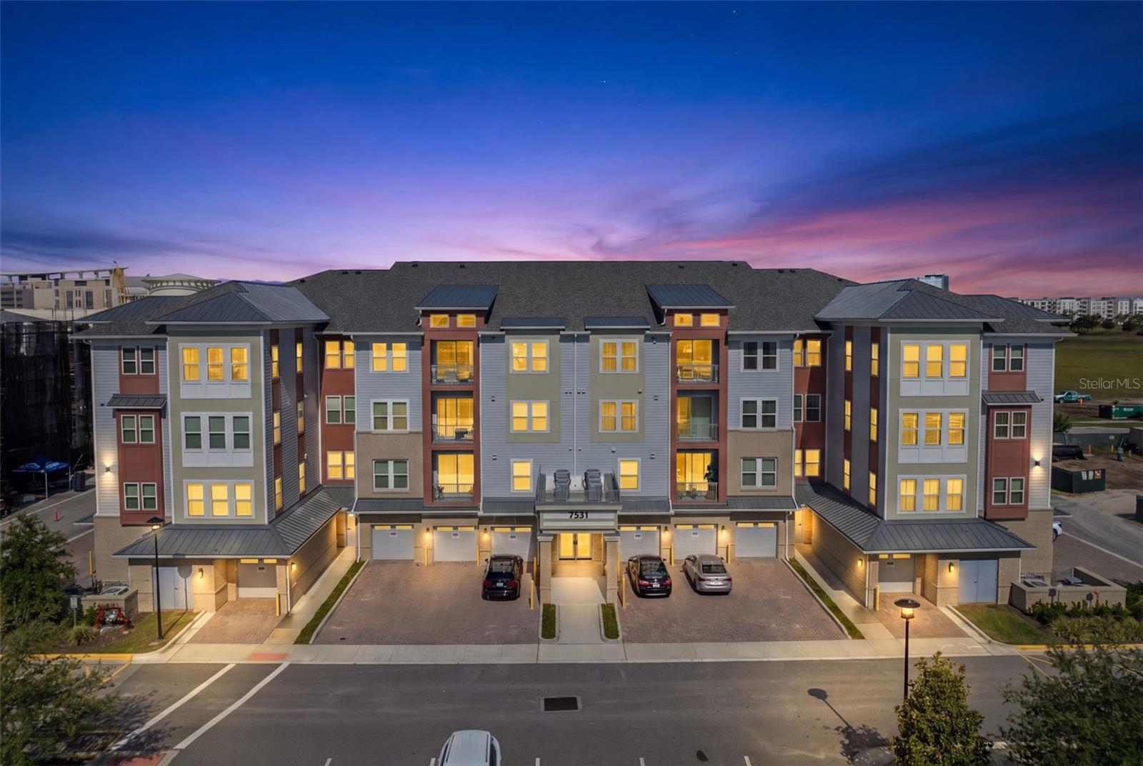 Welcome to effortless luxury living in this beautifully upgraded end-unit Dogwood model in the highly sought-after 55+ Gatherings® of Lake Nona community. Built in early 2024, this exceptional 3-bedroom, 2-bath residence offers a versatile third bedroom that can easily serve as a den, sitting room, reading room, or home office to fit your lifestyle.

Flooded with natural light from 16 windows, all featuring plantation shutters, the home also boasts remote-controlled blackout blinds in the bedrooms and a remote-operated storm shutter on the private balcony. The open-concept floor plan showcases elegant designer finishes throughout, including three stunning chandeliers, custom draperies, upgraded lighting fixtures, and beautifully replaced mirrors in both bathrooms. The spacious kitchen flows seamlessly into the living and dining areas, creating the perfect space for entertaining.

The primary suite offers a peaceful retreat with a large walk-in closet, linen closet, dual vanities, soaking tub, and separate shower. The guest bathroom has been upgraded with a $28,000 Kohler therapeutic walk-in tub, providing exceptional comfort and accessibility. Additional improvements completed in 2024 and 2025 include custom cabinetry in the laundry room and numerous thoughtful upgrades throughout.

Additional storage is provided by an oversized 7' x 11' climate-controlled storage room conveniently located on the first floor, along with a private, deep garage and dedicated parking space.

Residents enjoy a true resort-style, maintenance-free lifestyle with an impressive collection of amenities. The beautifully appointed clubhouse features a fitness center, game room, library, entertaining room, indoor kitchen, and flexible gathering spaces. Outdoors, enjoy a heated resort-style pool surrounded by private cabanas, two inviting fire pits, an outdoor lanai with grills, pickleball and bocce ball courts, an outdoor fitness area, scenic walking paths around the amenity lake, a gated dog park, and a vibrant calendar of social activities designed to keep you as active and engaged as you'd like to be.

HOA dues include cable, high-speed internet, grounds maintenance, exterior insurance, elevator maintenance, controlled access, exterior pest control, exterior window cleaning, amenity maintenance, and reserves.

Conveniently located just minutes from Medical City, the VA Medical Center, Orlando International Airport, shopping, dining, and major highways, this home offers the perfect combination of luxury, convenience, and active adult living.