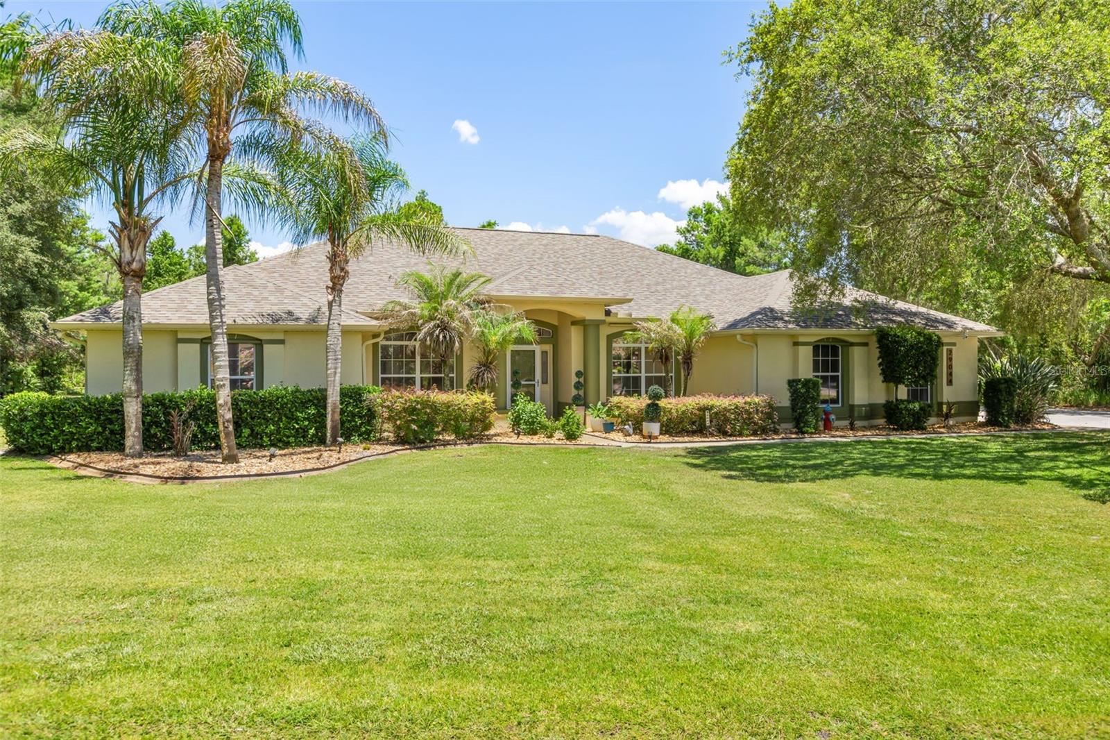 Set on a full acre in the community of Old Mill Run, this Tavares pool home pairs space and privacy with a location built for golf and lake life. The standout is a detached 30x45 workshop, fully insulated, with 600 square feet air conditioned and 750 square feet non air conditioned, making it ideal for hobbies, a home business, a fitness room, or climate controlled storage. With a full acre and that kind of shop space, this is the property to bring all of your toys, whether that means a boat, an RV, or a collection of cars. Inside, hardwood floors run through living spaces filled with natural light. A custom one-of-a-kind bar room adds a distinctive touch, finished with walnut shelving and a granite bartop. Outside, a sparkling screened pool sits at the center of a private backyard framed by lush, mature landscaping. A summer kitchen makes outdoor cooking and entertaining easy. A whole house generator keeps the home running year round. Deer Island Country Club is a short golf cart ride away, and a public boat ramp with access to the Harris Chain of Lakes sits only minutes from the driveway, putting a morning round and an afternoon on the water within reach of the same day. A full acre, a sparkling screened pool, and a workshop with room for every toy, all minutes from golf and the lakes. Call today for your private showing.