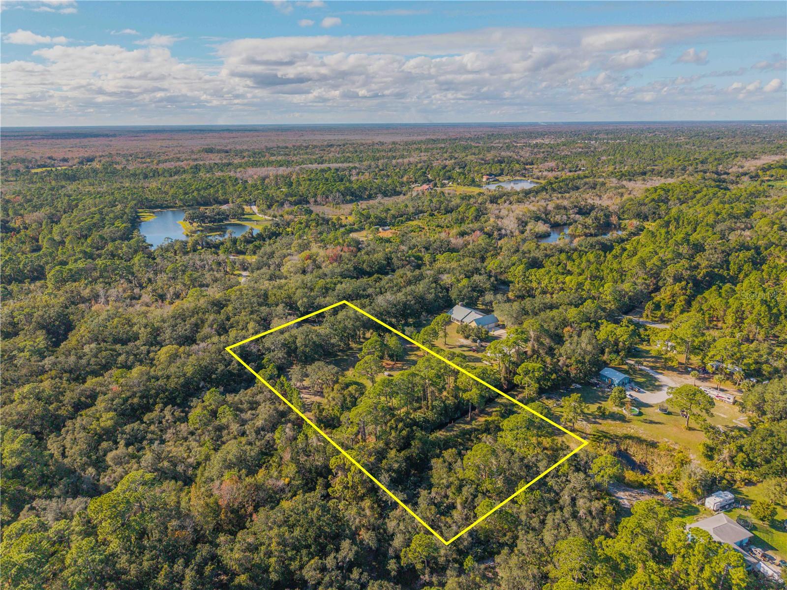 Build your dream home tucked away, beneath a canopy of mature Florida trees, this 3.+-acre fenced parcel offers a rare opportunity to own an authentic piece of Old Florida. Private, peaceful, and naturally beautiful, the property provides an ideal backdrop for a custom country estate/family compound, weekend retreat, or thoughtfully designed Barndominium.  Here, mornings begin with quiet breezes and birdsong, and evenings settle beneath wide open skies—yet you’re never far from modern conveniences. Enjoy easy access to shopping, local waterways, fishing, boating, pristine beaches, NASA, and Central Florida’s renowned attractions. This location delivers the freedom of rural living paired with everyday accessibility. Zoned RT within the City of Edgewater, this parcel invites you to bring your vision to life in a setting that feels far removed from the rush, while still connected to everything that makes the area so desirable. Expand your possibilities another 3.40 acres, as this property is contiguous to 480 Clinton Cemetery Rd MLS NS1086782. Opportunities like this—where privacy, natural beauty, and location converge—are increasingly rare.