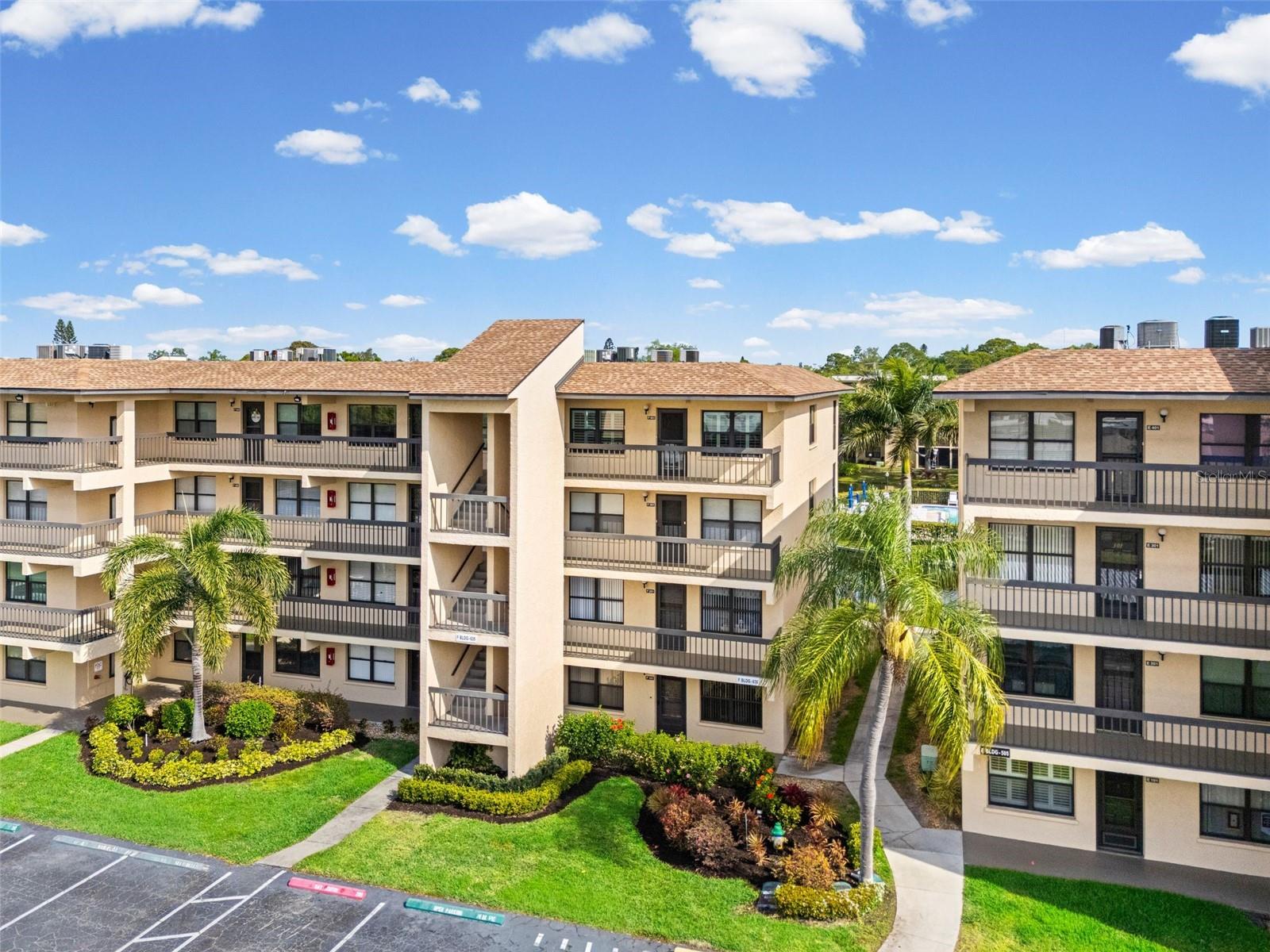 This top-floor penthouse condo offers an outstanding opportunity for buyers looking to renovate and create their ideal home. Featuring 2 bedrooms and 2 bathrooms, it's located in the desirable 55+ gated Woodpark community, a neighborhood that residents often describe as a true "hidden gem."Ideally situated in one of the quietest and most scenic areas of the neighborhood, this top-floor unit delivers both privacy and stunning surroundings. The screened balcony provides tranquil views of lush greenery, perfect for relaxing.  The dining area is conveniently located just off the kitchen and flows seamlessly into the inviting living room, creating an open and cohesive layout ideal for everyday living and entertaining. The oversized primary suite easily accommodates a king-size bed and includes private bathroom with a walk-in shower, as well as a spacious walk-in closet. A split-bedroom floor plan ensures excellent privacy for guests, with the second bedroom also well-suited for use as a home office. A second full bathroom with a bathtub is located off the hallway, adding both convenience and privacy. Additional features include a private washer and dryer, a 4x4 storage space perfect for seasonal items and beach gear, and a covered carport conveniently located near the elevator. Woodpark offers resort-style amenities, including a large heated pool, clubhouse, wooden deck with shaded tables, barbecue area, shuffleboard courts, and walking trails. The pet-friendly community’s HOA fee covers cable, internet, water, sewer, trash, and all amenities—owners only pay for electricity. Conveniently located near shopping and dining, this condo is just a short drive to the beautiful beaches of Anna Maria Island. Nearby Sarasota’s renowned St. Armands Circle offers upscale shopping and vibrant nightlife, perfect after a relaxing day at Lido Beach. Living at Woodpark truly feels like a year-round vacation in a peaceful, resort-style setting.