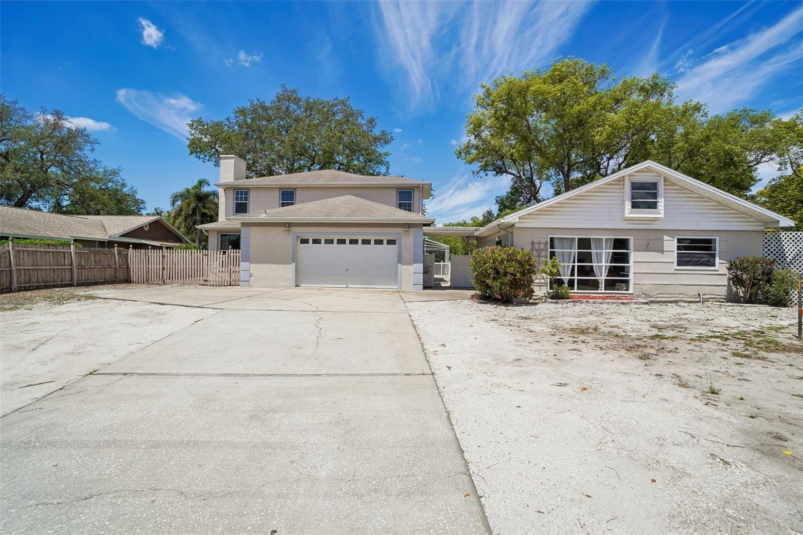 Rare Dunedin opportunity with two separate living structures, a screened pool, generous parking, and flexible living space designed for today’s multi-use lifestyle. Set on an oversized fenced parcel, the 2001-built main residence offers 2,526 square feet with 4 bedrooms, 2.5 bathrooms, a 2-car garage, formal living and dining areas, and a spacious family room with fireplace. The bright interior features soaring ceilings, oversized windows, an open flow between the main living spaces, granite kitchen counters, abundant cabinetry, tile flooring throughout the main level, and multiple areas for gathering, working, or relaxing from day one.
The main home’s floor plan creates excellent separation between everyday living and private retreats. The oversized 24x12 primary suite provides room for a king-sized bed plus a sitting area, reading nook, or desk setup, while the upstairs landing with built-in shelving adds character and functional storage. Major confidence points include HVAC replaced in 2022, an insulated garage door, and a garage mini-split that makes the space ideal for a home gym, workshop, hobby area, or climate-controlled storage. The screened-in pool and covered outdoor areas extend the living space outdoors, creating an easy indoor/outdoor lifestyle for entertaining, relaxing, and enjoying Florida living.
The detached 1953 guest house adds approximately 676 square feet of independent living space with 1 bedroom, 1 full bathroom, kitchen, living area, private entrance feel, and warm exposed wood beam ceilings that give it a charming cottage-style atmosphere. This second structure is ideal for in-laws, extended family, guests, adult children, a private office, creative studio, or potential long-term rental income estimated around $1,100–$1,300 per month. Public records reflect the property as single family with more than one house per parcel, with multi-family land use under 10 units. 
Located in highly desirable Dunedin, this property places you close to the lifestyle buyers are looking for: downtown Dunedin restaurants, breweries, boutique shopping, waterfront parks, TD Ballpark, the Pinellas Trail, Dunedin Causeway, Honeymoon Island, and Caladesi Island access. Honeymoon Island is known for Gulf views, sandy beaches, and nature trails, while the Pinellas Trail offers a dedicated corridor for biking, walking, jogging, and skating.  Downtown Dunedin also offers year-round events, local markets, arts, dining, and spring training baseball, adding strong lifestyle appeal for full-time residents, seasonal owners, and investors. 
Enjoy convenient access to nearby beaches, shopping, grocery options, marinas, parks, US-19, downtown Clearwater, St. Petersburg, and Tampa International Airport. Dunedin is approximately 15 minutes from Honeymoon Island and about 30 minutes from Tampa International Airport, depending on traffic.  With two living structures, a pool, flexible parking, income potential, and a location near some of Pinellas County’s most loved coastal amenities, this property offers a unique combination of comfort, versatility, and long-term value. Schedule your private showing today and experience all this Dunedin property has to offer.