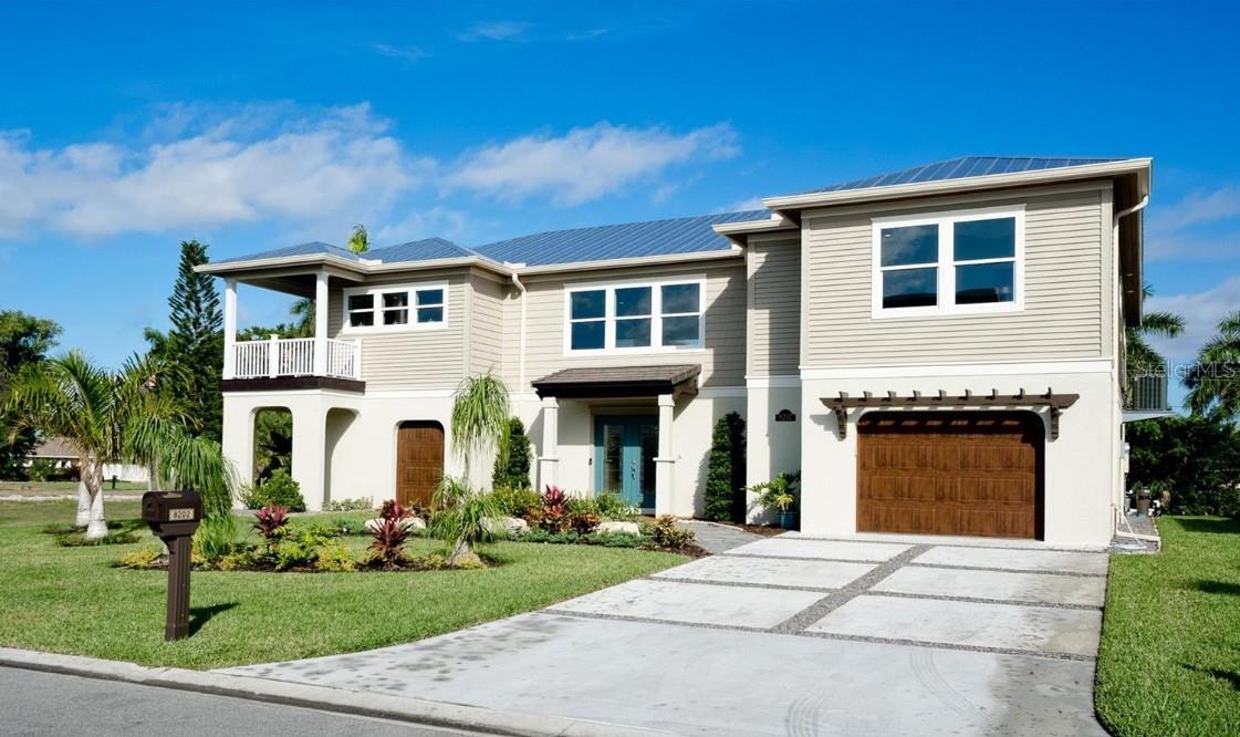 Experience elevated coastal living in this beautifully appointed executive residence with timeless West Indies-inspired architecture, now available for annual lease in the highly sought-after Palma Sola Bay area. Offered furnished with designer-selected interiors, this custom-built home blends luxury, comfort, and effortless Florida living. The thoughtfully designed open-concept floor plan features a stunning chef-inspired kitchen, expansive gathering spaces, and three spacious en suite bedrooms offering exceptional privacy and comfort. Upstairs, enjoy the convenience of a second-floor laundry room and start or end your day on the private coffee deck while taking in breathtaking sunset views over Palma Sola Bay. Additional highlights include a double EV charging station in the garage for modern convenience. Outside, your private resort-style retreat awaits with a sparkling pool, ping pong table, and inviting outdoor living space anchored by a cozy gas fireplace—perfect for entertaining or unwinding after a day at the beach or training. Ideally located just 5 miles from IMG Academy, this home is an exceptional opportunity for IMG families seeking a luxury seasonal base or executive relocation residence, with quick access to Anna Maria Island’s world-famous beaches, boating, kayaking, hiking, premier shopping, dining, major league sports, and convenient access to Tampa, St. Petersburg, Sarasota, and Orlando. No flooding or hurricane damage. Enjoy the Florida lifestyle at its finest.