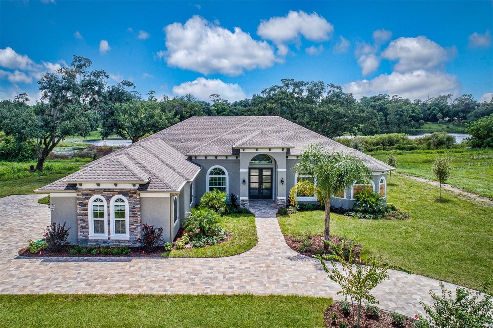 Pre-Construction. To be built. Some lots provide a view. This one provides a backdrop. Nestled within the exclusive gated community of Deer Island, this 0.33-acre interior homesite sits at the quiet edge of the golf course, where a serene natural pond creates a lush, private buffer between your future backyard and the fairway beyond. Just the kind of effortless seclusion that typically commands a premium, yet here, it simply comes with the land. Deer Island offers à la carte monthly boat dock rentals, giving you instant access to the legendary Harris Chain of Lakes from the moment you arrive; just the water at your fingertips. With no time restriction to build, your vision unfolds entirely on your terms and your timeline. The rendering from Kevco Builders shown is for inspiration only (Barcelona 2500 model). Buyers are welcome to build from a completely custom floor plan or make changes to suit their lifestyle (price is subject to change based on the floor plan and size of the home). The generous lot size gives an architect true creative latitude, with ample room for a pool, while the pond-side orientation invites outdoor living spaces designed to make the most of the scenery: a covered lanai, the scent of the evening breeze, and a view that quietly resets the day before the sun even sets. Deer Island is a rare 400-acre natural island cradled by Lake Dora and Lake Beauclair on the legendary Harris Chain of Lakes. At its heart sits the Deer Island Country Club, home to an award-winning 18-hole championship golf course recognized among America's Top 50 Public Courses and ranked #5 in the state of Florida.The club also features 19th Wave, a restaurant and bar, all within a short golf cart ride from your front door. Golf memberships are available, though never required; the choice, like everything here, is yours. Whether you're up for a morning ski run, an afternoon of fishing, a leisurely sunset cruise, or a quick boat ride into charming historic Mount Dora for dinner, the lake lifestyle here bends to your pace and is as adventurous or as still as you want it to be. Orlando's world-class attractions are roughly 45 minutes away. Both the Atlantic and Gulf Coast beaches are within about 90 minutes. And yet, once you're on this island, the outside world feels just far enough. This is the kind of lot that rewards you long before a single wall goes up. Come walk the property. Listen to the stillness. And picture what life looks like when home backs up to something truly beautiful. * The photos of the house are of a previously built home. Some features and finishes are optional and can be discussed with the builder. *