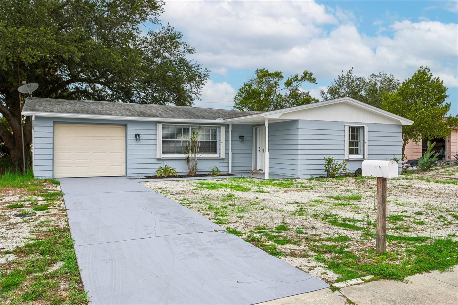 Welcome to this beautifully updated two-bedroom, two-bathroom home with a one-car garage. This home features a remodeled kitchen with updated cabinets and countertops, complemented by two fully renovated bathrooms. Enjoy new wood laminate flooring throughout and fresh interior paint, creating a clean and modern feel. Major updates include an updated AC system and a brand-new roof to be installed prior to closing, providing added value and reassurance for the next owner. Step outside to a screened, covered back patio-perfect for relaxing or entertaining year-round. The home is also equipped with rollaway shutters on nearly every window and door opening for added protection and convenience. Best of all, this property did not flood during Hurricane Helene or Hurricane Milton.