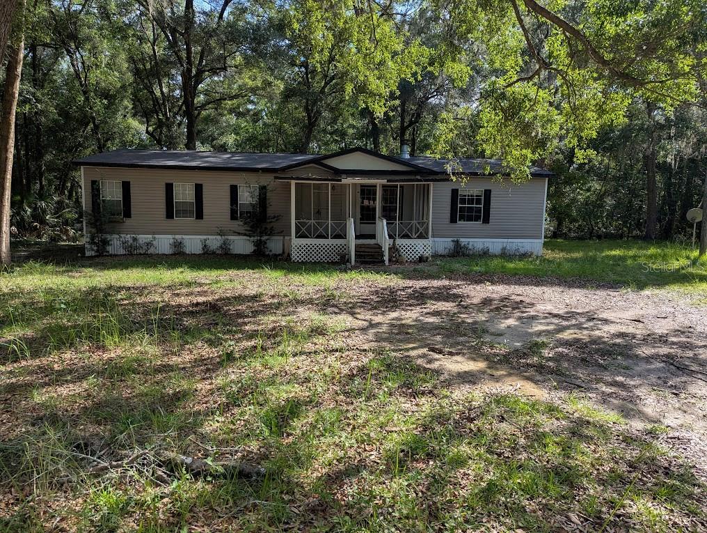Close to Haile/Tower Road this well kept doublewide mobile on the cul-de-sac has plenty of space inside and out. 3 large bedrooms and 2 baths with primary bedroom having an extra space that could be used as an office, nursey or even craft area.  Open floor plan and fireplace allows for great entertaining or cozying up to stay warm. Seller is a licensed FL Real Estate Agent.
