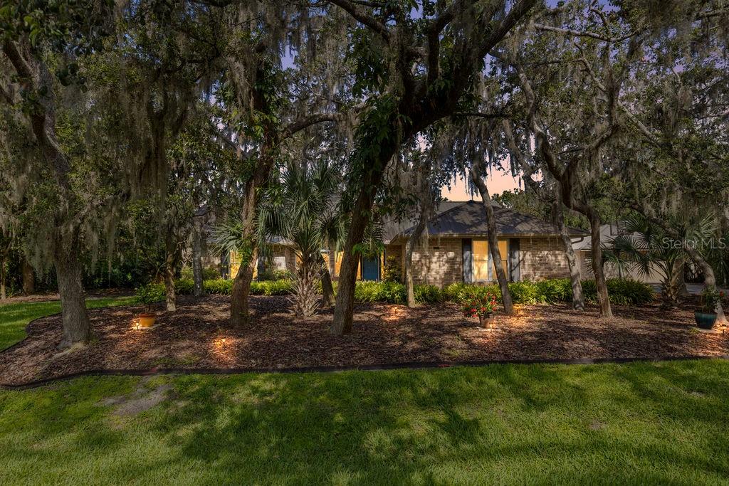 Welcome to your private slice of Florida paradise! Nestled in the quiet and established community of Nellie Oaks, this beautifully maintained custom pool home sits on an oversized lot surrounded by mature trees and serene natural beauty. This charming neighborhood offers exclusive access to the Clermont Chain of Lakes, where you can enjoy boating, fishing, and water sports right from the private community boat ramp and dock. Spend your weekends exploring the lakes, or cruise by boat to local restaurants, the downtown Clermont farmers market, shops, bars, and community events, a true lake lifestyle at your doorstep. Step inside to discover a light-filled, open-concept layout with vaulted ceilings and warm finishes throughout. The updated kitchen is a dream for home chefs, featuring granite countertops, stainless steel appliances, and a large breakfast bar overlooking the spacious living and dining areas, ideal for both entertaining and everyday living. The split floor plan offers privacy and function, with a generous primary suite that includes an oversized walk-in closet and an en suite bath with soaking tub, separate shower, and dual vanities. Step outside to your screened-in pool and large covered porch, perfect for entertaining and enjoying Florida’s sunshine year-round. The backyard offers plenty of green space, privacy fencing, and room to garden or play. With no rear neighbors in sight, it’s your own peaceful retreat. Enjoy the tranquility of country-style living, yet you're close to downtown Clermont, the Chain of Lakes, major highways, and 2 hours from beaches on either coast. Bring your boat, RV, or outdoor toys...there’s room for it all! Don’t miss this rare opportunity to live in a beautifully updated pool home in a charming, tucked-away neighborhood.