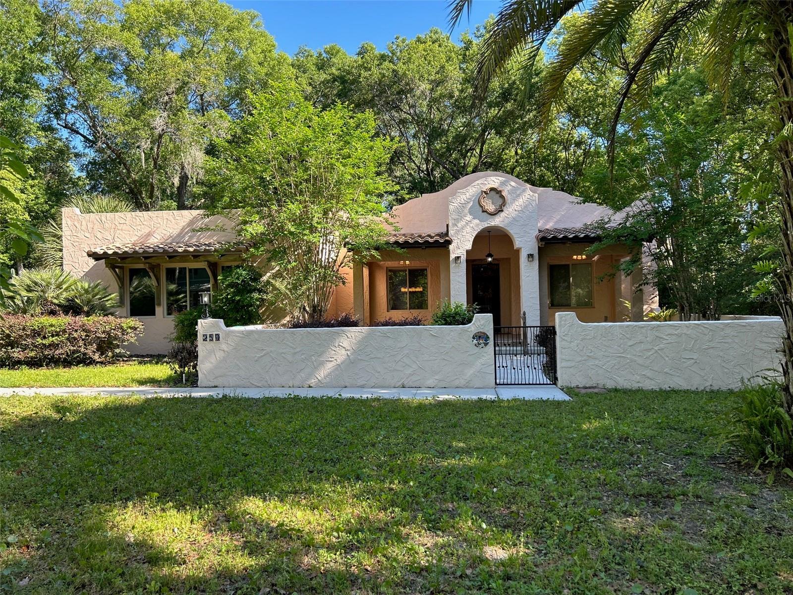 BEAUTIFUL AND UNIQUE CUSTOM HOME ON 1/3 ACRE LOT IN HEART OF LAKE HELEN. FANTASTIC LOCATION. NO HOA HERE.  THIS 3 BEDROOM 2 BATH GEM BOASTS A SPLIT PLAN WITH 2 PRIMARY SUITES AND A THIRD BONUS ROOM CAN ALSO BE A 3RD BEDROOM. DESIGNED FOR COMFORT AND FLEXIBILITY.  THE FIRST PRIMARY SUITE OFFERS A LARGE, SPACIOUS BATHROOM WITH SOAKING TUB, SEPARATE SHOWER, WATER CLOSET, AND TWO WALK IN CLOSETS. THE SECOND PRIMARY SUITE INCLUDES A PRIVATE BATH WITH A TUB SHOWER COMBO, IDEAL FOR GUESTS OR MULTIGNERATIONAL LIVING. 
VAULTED CEILINGS AND AN OPEN FLOOR PLAN AND SKYLIGHTS CREATE A BRIGHT, AIRY FEEL THROUGHOUT THE MAIN LIVING AREAS.
 THE KITCHEN SHOWCASES CUSTOM WOOD CABINETRY AND GRANITE COUNTERTOPS. CUSTOM FEATURES CAN BE FOUND THROUGHOUT THE HOME, ADDING CHARACTERR AND THOUGHTFUL DESIGN ELEMENTS AT EVERY TURN.
ADDITIONAL INTERIOR HIGHLIGHTS INCLUDE A SMALL OFFICE, INDOOR LAUNDRY ROOM AND ABUNDANT STORAGE.
ENJOY TRUE INDOOR-OUTDOOR LIVING WITH EXPANSIVE SCREENED WRAP AROUND BACK PORCHES. THE HOMES SLIDING DOORS FOLD INO THE WALL OPENING THE HOME TO ADDITIONAL LIVING SPACE DURING THE COOLER MONTHS. THE FRONT OF THE HOME FEATURES INVITING COVERED PORCHES OVERLOOKING A CHARMING COURTYARD, PERFECT FOR RELAXING OR ENTERTANING.