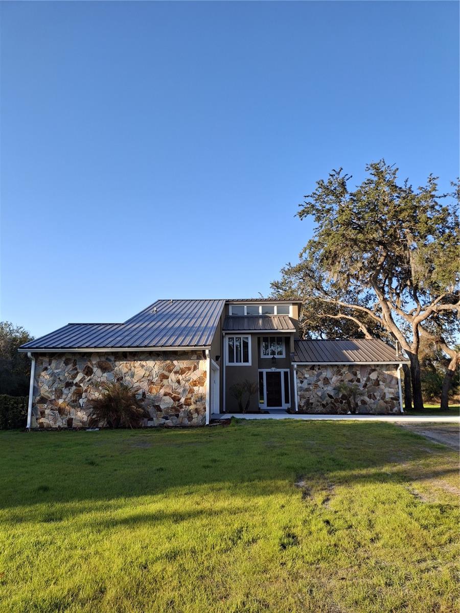 THERE IS NO OTHER LIKE THIS ONE. IT'S A CUSTOM-BUILT HOME FROM ONE OF THE BEST BUILDERS AROUND. ALL NEW TEXTURED CEILINGS WALLS AND PAINT THROUGHOUT, NEW KITCHEN 2 LAZY SUSANS BIG DEEP SINK ALL WOOD SOFT TOUCH CLOSING CABINETS  EXTRA LARGE PANTRY.  ALL NEW CAN LIGHTING AND STONE COUNTERTOPS.  SNACK BAR COUNTER NEXT TO THE DINING ROOM WITH SLIDERS TO GO OUTSIDE TO A COVERED PATIO FOR GRILLING OR JUST TO RELAX.  THE PRIMARY BEDROOM UP STAIRS OFFERS ITS OWN NEW SLIDERS THAT OPEN UP ONTO A PRIVATE BALCONY OVERLOOKING THE HOLE BACK YARD WITH ITS BEAUTIFUL OAK TREES INSIDE IS THE MOST BEAUTIFUL STONE FIREPLACE,  THIS 2 STORY IS SUCH AN EYE CATCHER IT'S A MUST TO SEE AND IT SITS ON 2.5 ACRES +- AND ITS ONLY HALF CLEARED.  SO MUCH ROOM THE IDEAS ARE ENDLESS.    City Water and Septic tank!   Survey in office!    Metal roof installed in 12-2025.    R V.   Hookup and pad. ! YES HORSES AND LIVE STOCK WELCOME. TRUCKS AND EQUIPMENT PLENTY OF PARKING.  ALL NEW DRIVE WAY.