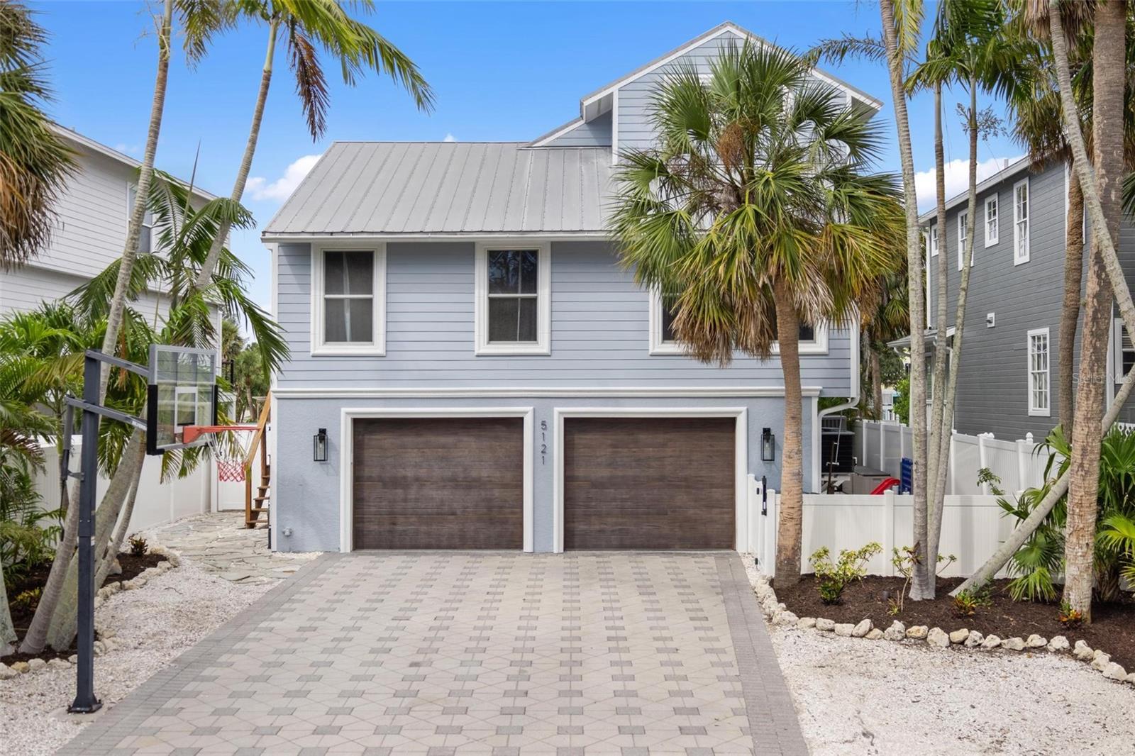 What if every weekend felt like a vacation, and every vacation felt like home? Perfectly positioned just minutes from the powder-soft sands of Siesta Beach and the restaurants, boutiques, and nightlife of Siesta Key Village, yet tucked away on a quiet, oak-canopied street, 5121 Oxford Drive offers something increasingly rare: the ability to truly have it all. Whether you're searching for the ultimate family retreat, a luxury second home where lifelong memories are made, or a waterfront property with exceptional vacation rental potential, this home delivers the lifestyle buyers dream about without the compromises they dread. Forget spending months managing contractors, unexpected repairs, or costly renovations. Nearly every major component has already been upgraded, including a new deep-water dock with 10,000 lb. boat lift (2025), impact-rated Low-E sliders and doors (2025), new HVAC systems (2025), whole-home dehumidifier (2025), heated saltwater pool (2024), spa-inspired primary bath (2024), designer kitchen (2023), tankless water heater, hurricane-rated garage doors, climate-controlled garage, metal roof, and stunning Cumaru Brazilian teak wraparound balconies. Simply unpack and start living. Spend your mornings watching boats glide down the Grand Canal with coffee in hand, your afternoons cruising Sarasota Bay from your private dock just minutes away, and your evenings taking the golf cart to Siesta Village for dinner, live music, or a sunset walk on America's most celebrated beach. With 50 feet of deep-water frontage, boating isn't an occasional event—it's part of everyday life. For investors, few destinations generate year-round demand like Siesta Key, making this an exceptional opportunity to own a luxury property in one of Florida's most desirable vacation markets. For families, it's a place where children spend their days in the pool, weekends on the beach, and holidays become traditions that last for generations. This isn't simply another waterfront home. It's freedom from projects. Freedom from compromises. Freedom to enjoy the Siesta Key lifestyle the day you close. Homes that combine boating, beach access, golf cart convenience, luxury upgrades, and timeless coastal living in one complete package rarely become available. This is one of them.
