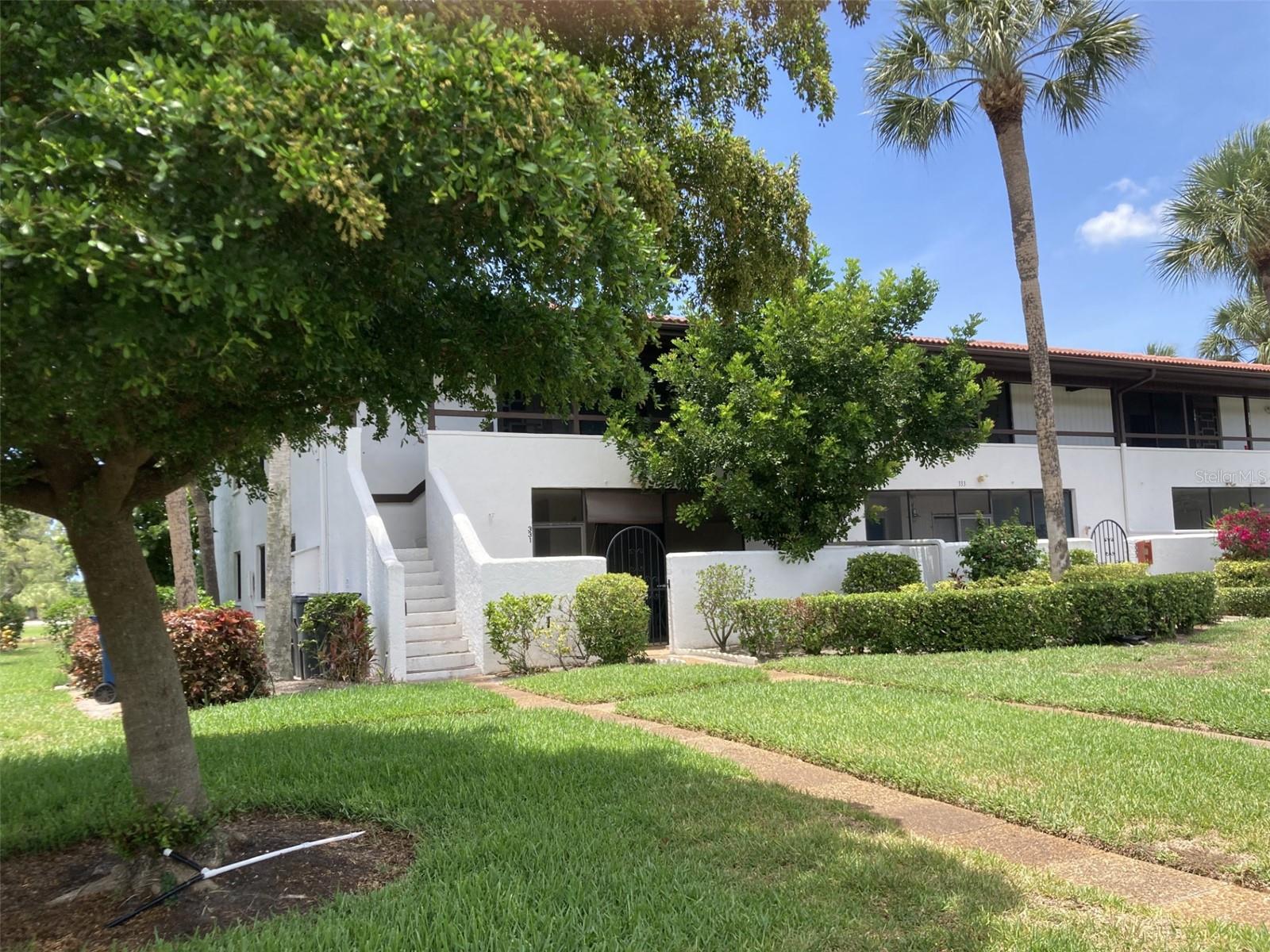 Great location with a view of a pond, driving range and golf course from this first floor corner two bedroom-two bath turnkey furnished condo located in the IMG Country Club area. Enter through a gated courtyard then into a front screened porch which has a walk-in storage-laundry room.  Very open floor plan - very light and bright! Living-dining area features bamboo flooring and crown molding with windows on the side and sliding glass doors to lanai.  Ceilings in kitchen and both bathrooms have been recessed.  There is a screened porch in the rear with sliding doors to living room and master bedroom.  Plenty of closet space.  The condo comes with a carport.  Walk across the street and the path will take you to a heated pool and spa.  IMG has an 18 hole regulation golf course open to the public, but also has memberships available.  There is a clubhouse situated on Sarasota Bay with beautiful views from both the grill room and dining room.  Close to IMG Academy, State College of Florida, many restaurants and shopping.  About 8 miles to the beach and approximately 15-20 minutes to Sarasota.