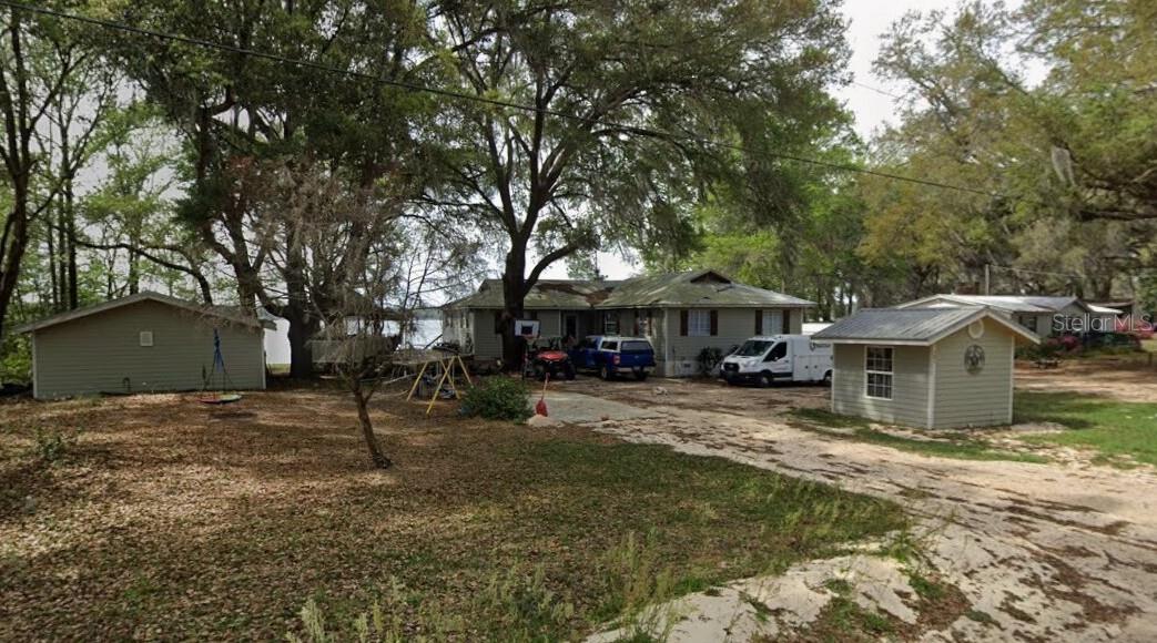**PRICED TO SELL** Incredibly rare lakefront opportunity on Grandin Lake, offering over 160 feet of direct waterfront and true “Lake Life” amenities at their finest. The owner’s relocation gives you the unique chance to secure this spacious 4 bed / 2 bath home on a double lot at the lowest price per sq ft in the area by far. Light cosmetic touches may be needed, but absolutely no major issues. So what makes this one so special? 1) Over 160 feet of direct frontage on Grandin Lake, a fully recreational 400+ acre lake perfect for wakeboarding, wakesurfing, skiing, fishing, and more. 2) Brand new metal (tin) roof installed in 2017 with a 25-year warranty. 3) Remodeled kitchen with ample space for entertaining and everyday living. 4) Fully renovated master bathroom featuring a large walk-in tile shower with multiple shower heads, including a ceiling rain feature. 5) Spacious 4 bed / 2 bath layout with large living and dining areas, fireplace, and tile, wood, and bamboo flooring. 6) Massive 1,440 sq ft half-wrap deck facing the lake, shaded by beautiful mature Live Oak trees. 7) Covered screened-in outdoor space attached to the deck, perfect for cooking, relaxing, and enjoying the breeze. 8) New central A/C system in 2016,  consisting of a Carrier 3-ton unit matched with an air handler inside. 9) Huge separate detached party room building complete with a full bar, double stainless steel sink, wine storage, full-size fridge, kegerator, and space for a pool table, poker table, darts and more. 10) Additional outdoor entertainment area attached to the party room with a 12x12 deck and fire pit overlooking the lake. 11) Large .4 acre double lot, providing ample storage space for RVs, boats, and all your toys, giving you the room and freedom to fully enjoy lake living. 12) Water softener system. 13) Remodeled dock. 14) Unmatched sunset views over the water that you’ll never forget. 
Properties offering this level of waterfront, land size, and entertainment potential are extremely rare. Whether you're looking for a primary lakefront residence, vacation home, or high-upside retreat, this property delivers the space, views, and endless lifestyle possibilities all in one package. Easy to show. No HOA/CDD. Feel free to soft pitch before writing anything up. MLS info sheet and disclosures available. No assignable contracts accepted.