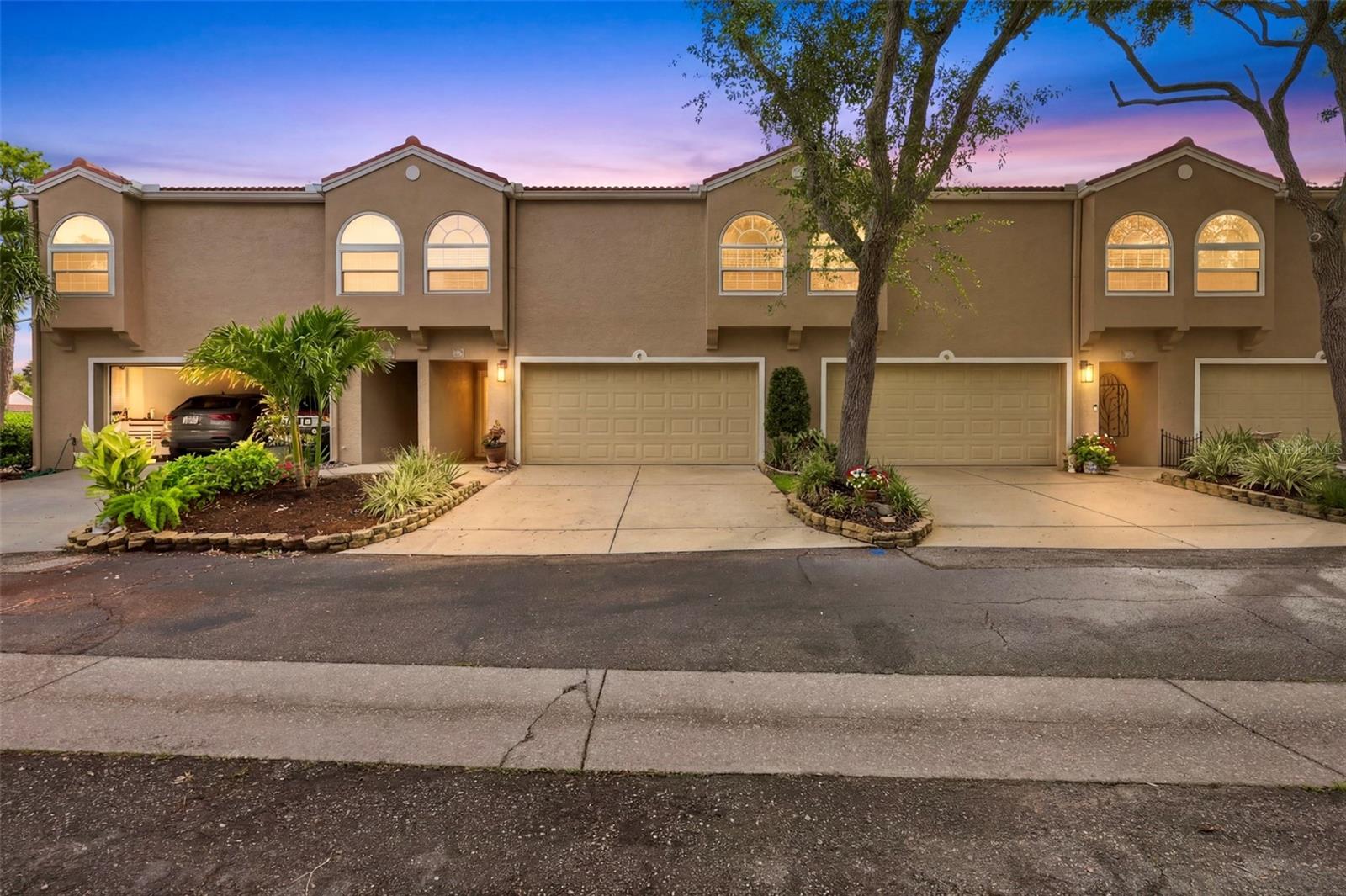 Welcome to your own slice of paradise in the prestigious GATED community of Placido Bayou—one of St. Petersburg's rare gated neighborhoods, offering security, tranquility, with a true lock-and-leave lifestyle. This beautifully maintained and tastefully updated two-story condominium features 2 bedrooms, 2.5 bathrooms, and an open, light-filled floor plan designed for comfortable living. Soaring vaulted ceilings, large skylights, expansive windows, rich wood flooring, and a cozy wood-burning fireplace create a warm and inviting atmosphere throughout the main living area. The updated kitchen is both stylish and functional, showcasing granite countertops, stainless steel appliances, decorative tile backsplash, breakfast bar seating, built-in wine storage, and a convenient desk workspace with additional cabinetry. Just off the living room, the enclosed Florida room provides the perfect flex space for relaxing, entertaining, or working from home, with direct access to the private patio and lush community green space. The first floor also offers a convenient half bath and an inside laundry room. Upstairs, the spacious primary suite features a walk-in closet and an updated en-suite bath with dual vessel sinks, an expansive vanity, and abundant storage. A generously sized second bedroom and full guest bath complete the second level. Additional upgrades include, BRAND NEW ROOF, a reverse osmosis water system, 2019 HVAC, and a 2022 water heater. The comprehensive HOA fee provides exceptional value by covering water, sewer, trash, exterior insurance, flood insurance, roof, exterior maintenance, landscaping, lawn care, community maintenance, guard-gated security, heated pool and spa with cabana and restrooms, 10 scenic lakes, and approximately one-mile of walking trail. This two-story condominium is exempt from Florida's milestone inspection requirements, providing added peace of mind. Ideally located just 4.4 miles from vibrant downtown St. Petersburg, you'll enjoy quick access to award-winning restaurants, museums, arts and entertainment, waterfront parks, The Vinoy, and the area's world-famous Gulf beaches. Whether you're searching for a full-time residence or a low-maintenance home that allows you to travel with confidence, this exceptional Placido Bayou property offers the perfect blend of comfort, convenience, and Florida living at its finest.