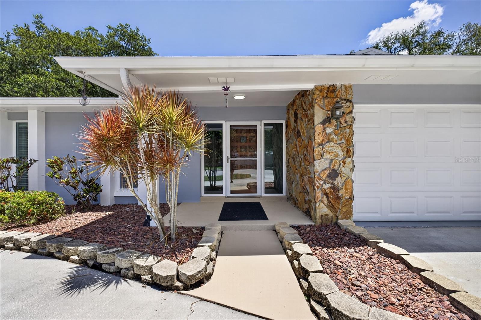 One or more photo(s) has been virtually staged. Tucked away at the end of a quiet cul-de-sac, this beautifully maintained 3-bedroom, 3-bath residence offers over 2,200 square feet of thoughtfully designed living space and an incredible indoor-outdoor lifestyle. Recently refreshed with a complete interior paint update, the home feels bright, clean, and move-in ready from the moment you step inside.

The spacious open-concept layout is anchored by a beautiful kitchen featuring rich solid wood cabinetry, granite countertops and backsplash, newer stainless steel appliances, a large peninsula with seating, and an additional center island perfect for entertaining or everyday living. The expansive living and dining areas flow seamlessly together, creating an inviting space filled with natural light.

Designed with privacy in mind, the split-bedroom floor plan offers two generously sized guest bedrooms and a full bath on one side of the home, while the oversized primary suite serves as a peaceful retreat on the other. The primary bedroom showcases a large walk-in closet and an updated ensuite bath with a newly renovated shower with abundant counter space.

One of the home's standout features is the massive 700+ square foot screened lanai, creating the perfect setting for year-round outdoor living and entertaining. Complete with an attached full bath and overlooking the private backyard, this space truly extends the home's living area outdoors.

Additional highlights include lifetime warranty hurricane-impact windows and sliders, newer solid wood interior doors, a 2025 roof, and a newer hot water heater. A private well-fed irrigation system efficiently maintains the beautifully landscaped grounds, adding both convenience and long-term value.The home also features an attached two-car garage and a large circular driveway with ample parking. 

Ideally located in a sought-after neighborhood with a low, optional HOA close to top-rated schools, beaches, shopping, dining, airports, and everything the Tampa Bay area has to provide, this is a rare opportunity to own a meticulously cared-for home in an exceptional location.