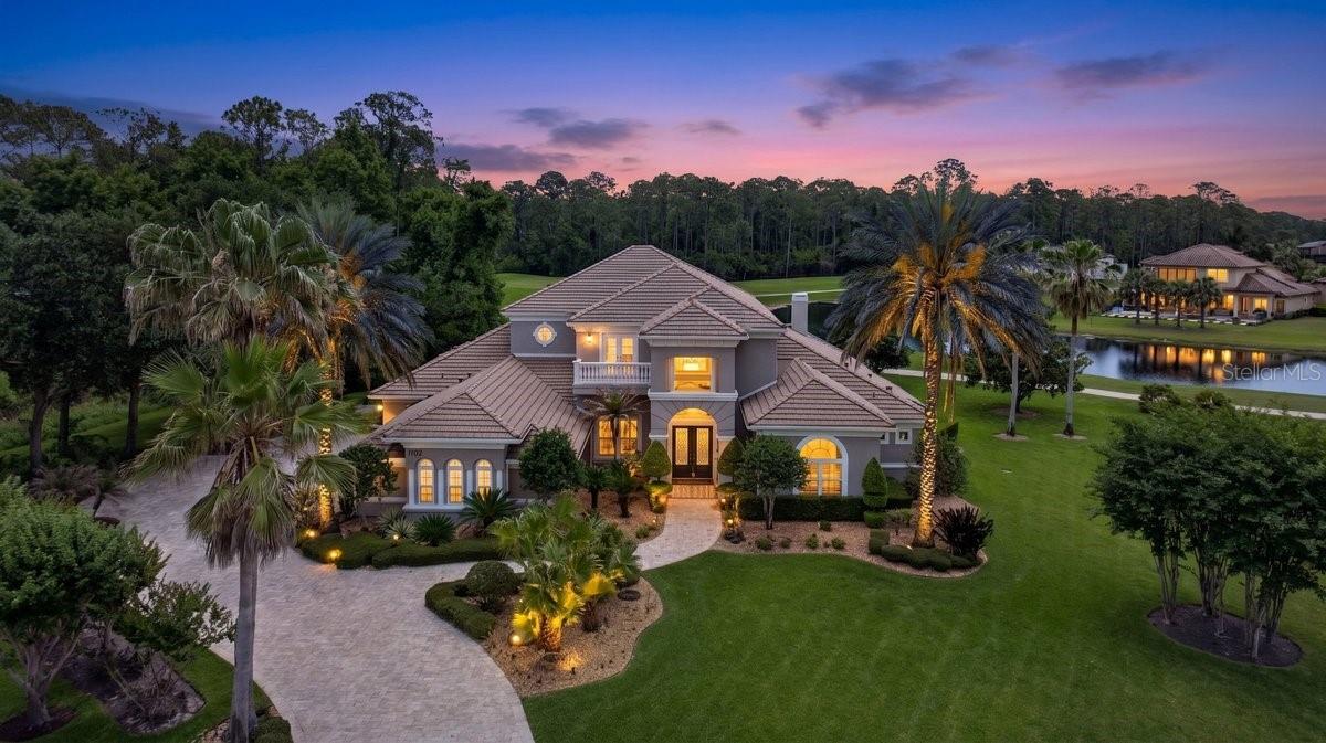 One or more photo(s) has been virtually staged. Nestled within the gates of Plantation Bay Golf & Country Club, this remarkable estate offers your discerning buyers an unparalleled opportunity to experience one of Ormond Beach's most coveted addresses. The home commands a spectacular position along the 7th fairway and 8th hole of the exclusive Prestwick Championship Golf Course, where sweeping fairway views frame this architectural masterpiece in natural beauty. A sweeping staircase rises beneath soaring ceilings, while formal living and dining spaces flow gracefully from the foyer, creating an immediate sense of grandeur and sophistication. A well-appointed powder room on the main level provides the convenience today's luxury homeowners expect. The heart of this home is undoubtedly the professionally remodeled kitchen, completed in 2018 to exacting standards. Custom cabinetry and premium countertops establish the foundation for what can only be described as a culinary enthusiast's paradise. The GE Monogram appliance package leaves nothing to chance; a gas cooktop, full refrigerator, dual ovens, and two dishwashers ensure this kitchen can handle everything from intimate family meals to catered galas. The expansive center island anchors the space with its own vegetable prep sink and disposal, while a generous walk-in pantry delivers the storage capacity serious entertainers require. The main level's thoughtful floor plan reserves an entire wing for the owners' retreat, a private sanctuary that begins with a dedicated office seamlessly connected to the suite. Inside the owners' quarters, a spacious sitting area provides the perfect spot for morning coffee or quiet reflection, enhanced by a dramatic double-sided fireplace that creates ambiance throughout the space. The luxurious owners' bath elevates daily routines with its oversized walk-in shower, while the exceptional walk-in closet features custom-built-ins that bring boutique-level organization to personal wardrobes. French doors open directly from the suite to the lanai, where you can step outside to enjoy your morning routine or evening cocktails surrounded by pristine golf course views. Ascending to the upper level reveals even more versatility and luxury. A second office with its own private balcony provides the ideal work-from-home environment or creative studio space. Adjacent to this, an impressive bonus room serves triple duty as a second living area, entertainment den, or media room. The built-in entertainment center anchors the space, while a sophisticated wet bar makes hosting upstairs gatherings effortless. Floor-to-ceiling doors open onto an expansive balcony that showcases unobstructed views across the Prestwick fairways, an entertainer's dream setting for gatherings. Step outside and you will discover your own private resort oasis designed for Florida's year-round outdoor lifestyle. The pool features a waterfall that creates both visual drama and tranquil ambiance, while the adjacent hot tub offers the perfect retreat after a round of golf or a long day at the beach. A fully equipped summer kitchen with everything needed to prepare and serve meals without stepping back inside. Multiple lounge areas thoughtfully positioned throughout the outdoor space provide options for every occasion, quiet morning coffee, afternoon poolside relaxation, or lively family gatherings that spill seamlessly from the lanai to the water's edge. Every detail has been designed to maximize the enjoyment of the spectacular golf course backdrop
