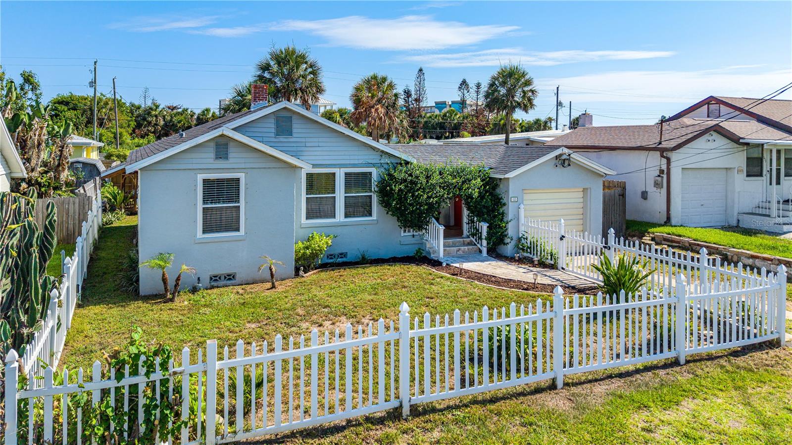 Tucked behind a charming white picket fence in the iconic Ocean Dunes area, this enchanting beachside bungalow offers the perfect blend of vintage charm and modern updates, just steps from the beach! Gorgeous hardwood floors and vintage glass doorknobs add timeless character, while the updated eat in kitchen features quartz countertops, soft-close cabinetry, high-end stainless steel appliances, and a glass tile backsplash. The main home offers 2 bedrooms and a beautifully renovated bath with updated tile flooring, modern vanity, and a luxurious steam shower with built-in radio. Major improvements include a 2022 roof, 2018 HVAC, updated windows, new ductwork in 2026, and new insulation. A separate bonus space with full bath and private deck is ideal as an office, art studio, gym, or in-law/guest suite. A covered breezeway connecting the main home and bonus space offers a charming place to sit and relax, while a backyard fountain creates a peaceful retreat. A rare beachside gem!