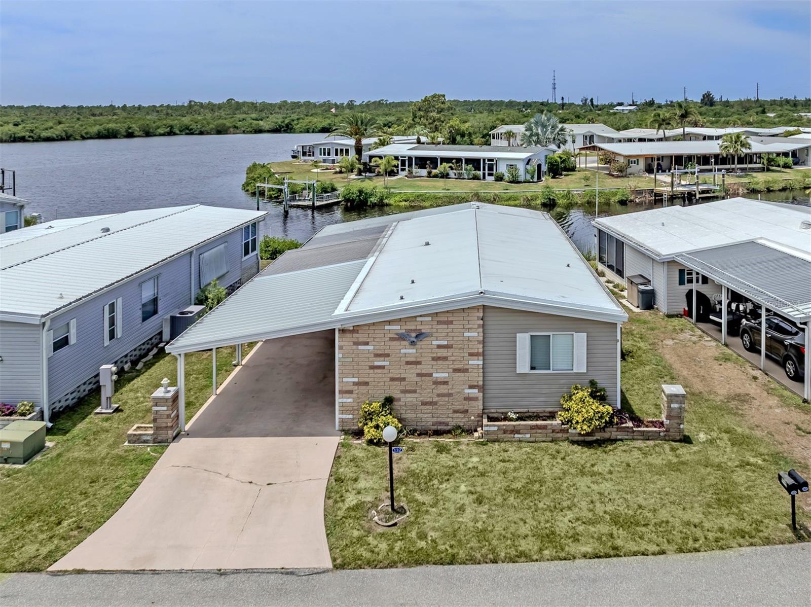 Wake up to breathtaking, ever-changing views of the Myakka River in this beautifully maintained 2 bedroom, 2 bath home located in the highly sought-after boating community of Lazy River Village. Perfectly positioned to capture spectacular 180-degree water views, this home offers a front-row seat to Florida’s natural beauty right from your own backyard.
Step inside to find a spacious, light-filled living area where large windows frame the river, creating a peaceful and inviting atmosphere. The kitchen is generously sized with updated cabinet doors and ample storage, making it both functional and stylish. Just beyond, a versatile bonus room provides the perfect space for a home office, den, or hobby area.
One of the true highlights of this home is the incredible Florida room, featuring acrylic windows and quality blinds, where you can relax year-round while taking in sweeping panoramic views of the water. Outside, a covered patio offers another tranquil space to unwind, entertain, or simply enjoy the river breeze.
Boating enthusiasts will appreciate the private dock just steps behind the home, offering easy access to the Myakka River and the Gulf of Mexico. Inside, both bedrooms are generously sized with large closets, while the guest bath features a beautifully tiled shower and the primary bath offers double sinks and abundant storage.
Additional updates provide peace of mind, including plywood subfloors throughout, a carport built to code just two years ago, a four-year-old A/C system, and new soffits around the entire home. Vinyl tile flooring throughout adds durability and a clean, cohesive look.
Lazy River Village is a vibrant, resident-owned, 55+ waterfront community known for its active lifestyle and exceptional amenities. Residents enjoy a marina, boat slips, kayak launch, and direct access to the Myakka River. The community also offers a clubhouse, pool, fitness center, tennis courts, pickleball and a full calendar of social activities, creating the perfect blend of relaxation and connection.
This is more than just a home—it’s a waterfront lifestyle with unmatched views and endless opportunities to enjoy the best of Florida living.