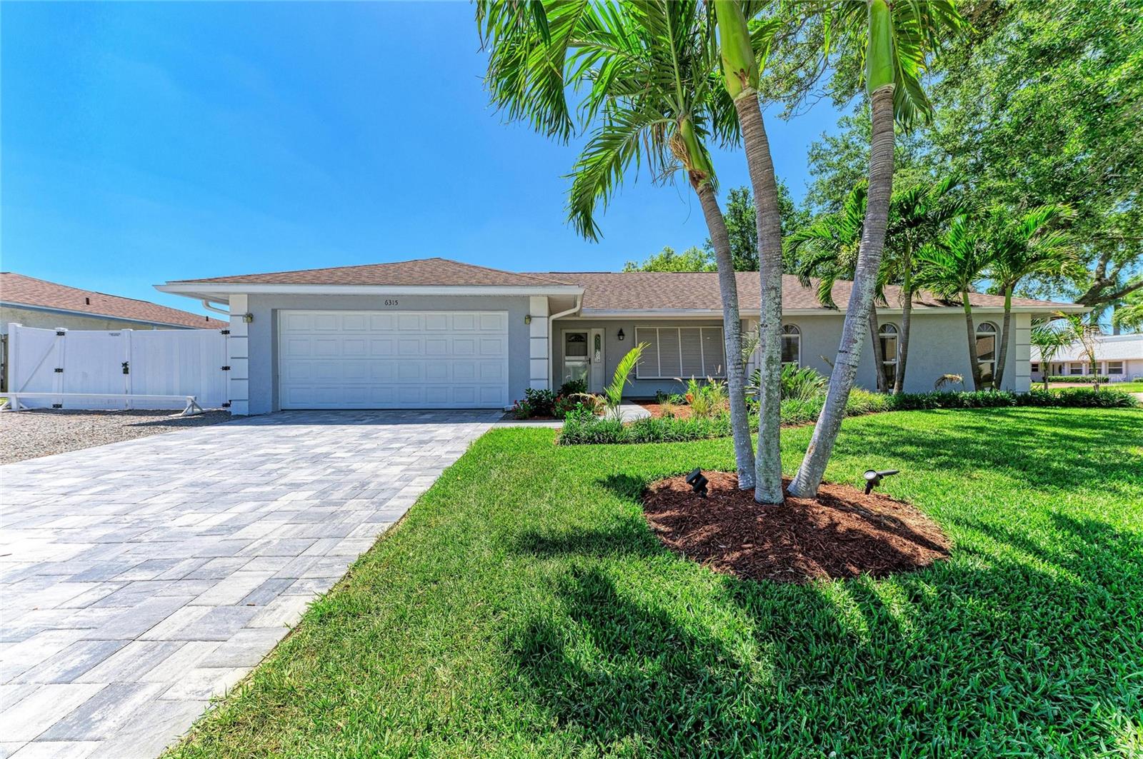 Nestled under a canopy of majestic oak trees in the heart of coveted Northwest Bradenton, this impeccably maintained residence offers the ultimate Florida lifestyle just minutes from the Warner’s Bayou boat ramp, the scenic trails of Robinson Preserve, and the historic De Soto National Memorial. Freshly painted both inside and out, the home radiates curb appeal on an expansive corner lot, featuring professional landscaping kept lush by a cost-effective well sprinkler system. The property is a rare find for outdoor enthusiasts, offering a fully fenced yard with room for a pool and two oversized double gates for secure boat or RV parking. The location is as convenient as it is beautiful, situated moments away from premier dining, local shopping, and the world-renowned Gulf beaches of Anna Maria Island.

Inside, the home has been reimagined with a focus on modern sophistication and smart functionality, boasting soaring high ceilings, new flooring throughout, and custom closets for effortless organization. The chef-inspired kitchen is a true centerpiece, fully updated with granite countertops, premium soft-close cabinetry, and integrated LED lighting with multiple dimmers to set the perfect mood. The primary ensuite serves as a private retreat, featuring a brand-new, luxurious marble shower. Every detail has been thoughtfully addressed—from the energy-efficient spray foam insulation in the attic and hurricane shutters to the modern convenience of an indoor laundry closet, multiple USB-equipped electrical receptacles, and a dedicated EV charging receptacle (240-volt 20 AMP) in the garage. Complete with a gas-burning fireplace and built-in animal doors for your four-legged family members, this home perfectly blends high-end comfort with the adventurous spirit of coastal living.