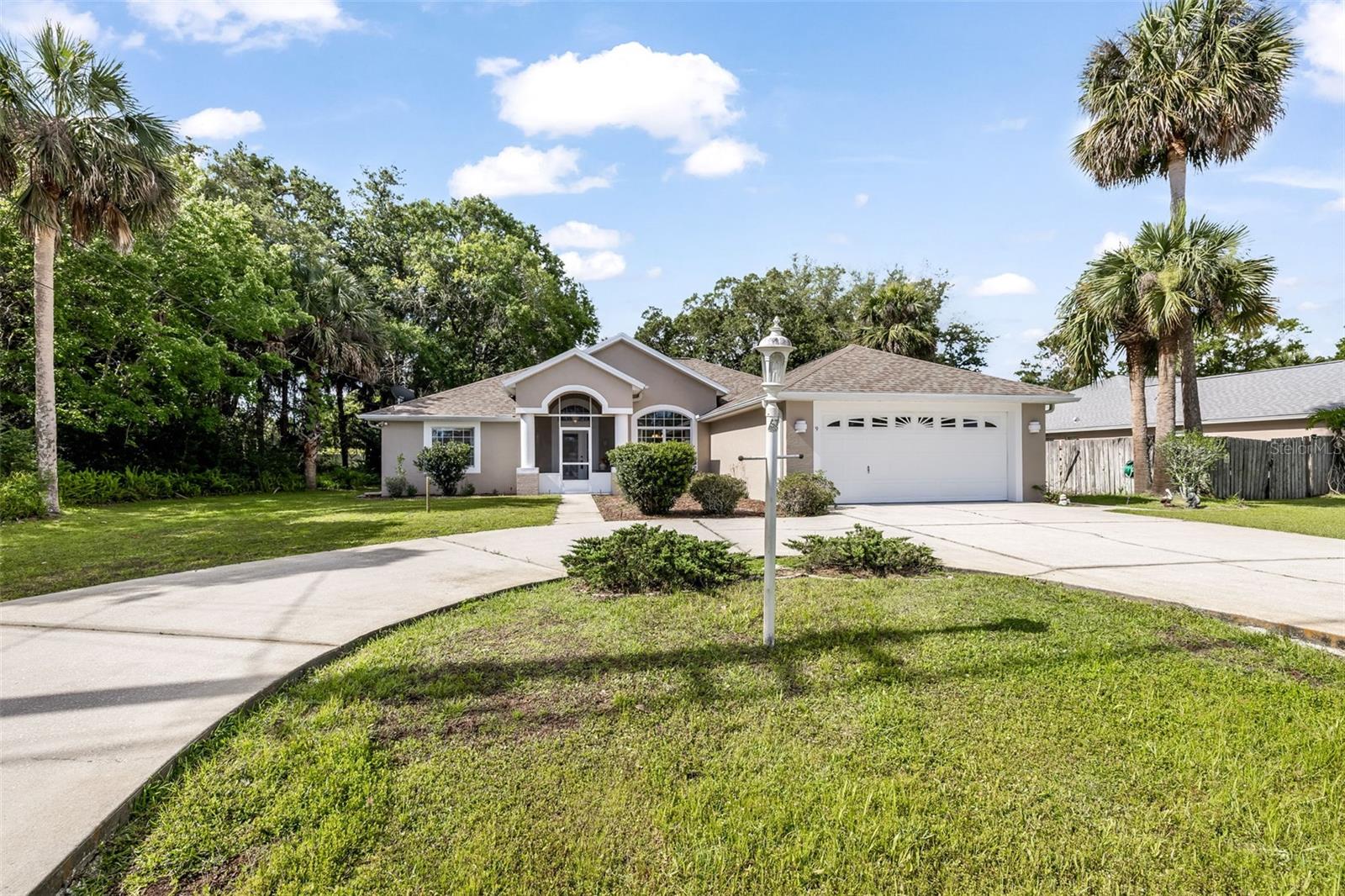 Step into comfort, charm and quality craftsmanship at 9 Whippoorwill Drive in Palm Coast. This beautifully maintained custom-built Sandcastle Home offers 3 bedrooms, 2 bathrooms, and 1,724 square feet of thoughtfully designed living space that feels warm and inviting from the moment you arrive. As you enter, you'll immediately notice the soaring 11-foot ceilings and abundance of natural light that create a bright, open atmosphere throughout the main living areas. Custom built-ins add character and functionality, while the cozy propane fireplace creates the perfect gathering space for family and friends. The spacious kitchen offers plenty of cabinetry, generous counter space and has the perfect place to sip your morning coffee at. To the right of the home you have your oversized primary suite, a peaceful sanctuary featuring beautiful windows that fill the room with natural light. The large en-suite bathroom offers a dual-sink vanity, large tiled corner shower, relaxing garden tub, separate wet area, linen closet, and a spacious walk-in closet. Guests and family members will appreciate the privacy of the split floor plan, with two generously sized bedrooms and a full bathroom located on the opposite side of the home. One of the home's most unforgettable features is the stunning glass-enclosed Florida room. Surrounded by windows, this light-filled space invites you to enjoy your morning coffee, curl up with a good book, or simply take in the beauty of your backyard year-round. Outside, you'll find a large partially fenced yard with room to garden, play, or relax, along with a metal storage shed for all your extra storage needs. The circular driveway offers plenty of parking and creates beautiful curb appeal. Additional features include a well-fed irrigation system, gutters surrounding the home, recently painted exterior, a 2022 roof and a 2016 HVAC system. All appliances can stay including the refrigerator, washer and dryer.  As an added bonus, this beautiful home can be sold fully furnished, allowing you to start enjoying the Florida lifestyle from day one. If you've been searching for a home that offers space, character, quality construction, and a welcoming atmosphere, this Palm Coast gem is ready to welcome you home.