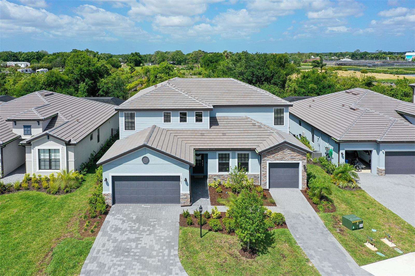 PRICE IMPROVEMENT! Discover unparalleled luxury in this stunning 2025-built Liberation floor plan WITH AN ENORMOUS FULLY FENCED IN BACK  YARD BACKING UP TO A WOODED PRESERVE in the prestigious gated community of Lorraine Lakes at Lakewood Ranch. This expansive 6-bedroom, 4½-bath home (3,867 sq ft heated) redefines Florida living with open-concept sophistication, effortless flow, and OVER $140,000 IN SELLER UPGRADES that elevate every detail.  Step into the bright, open first floor where the gourmet kitchen — featuring a massive quartz island, elegant rattan pendant lighting, and premium stainless steel appliances — seamlessly connects to the spacious family room, formal dining, and sunny breakfast nook. This inviting layout opens directly to the show-stopping screened lanai and resort-style saltwater pool plus spa with paver deck, natural-gas heater, and custom child-safety fence. The spacious fully fenced backyard creates a private haven, backing directly to a heavily wooded nature preserve that delivers breathtaking tree-lined vistas, unmatched tranquility, and spectacular sunsets right from your own lanai.  Upstairs, the second floor boasts a generous primary suite with spa-like garden tub and separate walk-in shower, four additional bedrooms, a large loft ideal for play, homework, or a second living area, and three full baths.  The attached Next Gen Suite is a game-changer for multi-generational living or guests: complete with its own private entrance, dedicated 1-car garage, cafe-style kitchenette, generous living room, bedroom, and full bath — all on the first floor for ultimate convenience. Sliding glass doors open directly to the pool, giving inhabitants seamless access to the rear yard paradise while maintaining complete independence.  IMPRESSIVE OWNER-ADDED UPGRADES ($140K+) INCLUDE:
• RESORT-STYLE SALTWATER POOL PLUS SPA, *NOTE- THE POOL MEASURES AN IMPRESSIVE 24X12, THE SPA SEATS 6-7 ADULTS AND MEASURES 7X7, THE POOL IS 5 1/2' AT IT'S DEEPEST END,  PAVER DECK, GAS HEATER & CHILD-SAFETY FENCE • 26KW GENERAC WHOLE HOME GENERATOR WITH AUTOMATIC NATURAL-GAS TRANSFER SWITCH FOR STORM-READY PEACE OF MIND
• FULLY FENCED REAR YARD 
• ENTIRE INTERIOR PROFESSIONALLY PAINTED WITH PREMIUM SHERWIN-WILLIAMS DURATION
• UPGRADED WOOD-LOOK TILE FLOORING THROUGHOUT THE ENTIRE FIRST FLOOR
• QUARTZ COUNTERTOPS THROUGHOUT THE ENTIRE HOME
• AIR-CONDITIONED GARAGE THAT DOES DOUBLE DUTY AS A HOME MOVIE THEATER, COMPLETE WITH EPSON HD PROJECTOR, ROKU, MINI-SPLIT AC, AND STORAGE RACKS
• CEILING FANS WITH REMOTES IN ALL 6 BEDROOMS PLUS LIVING AREAS PLUS LANAI
• UPGRADED POWDER ROOM, LAUNDRY ROOM CABINETS, OFFICE BUILT-INS/BOOKSHELVES, AND HIDDEN TV/ETHERNET WIRING THROUGHOUT  Additional features include hurricane shutters, split 3-car garage, and reclaimed-water irrigation.  ADDITIONAL BENEFITS:  THE HOA FEES COVERS LANDSCAPING, CABLE, AND HIGH SPEED FIBER OPTIC INTERNET! Lorraine Lakes and the broader Lakewood Ranch community deliver a world-class resort lifestyle: 24-hour guarded entry, clubhouse with social rooms and dining, state-of-the-art fitness center, resort-style pool with splash park, pickleball and tennis courts, playground, putting green, and over 150 miles of scenic trails, lakes, and nature preserves. Enjoy effortless access to top-rated schools, shopping, dining, and pristine Gulf beaches — all just minutes away.